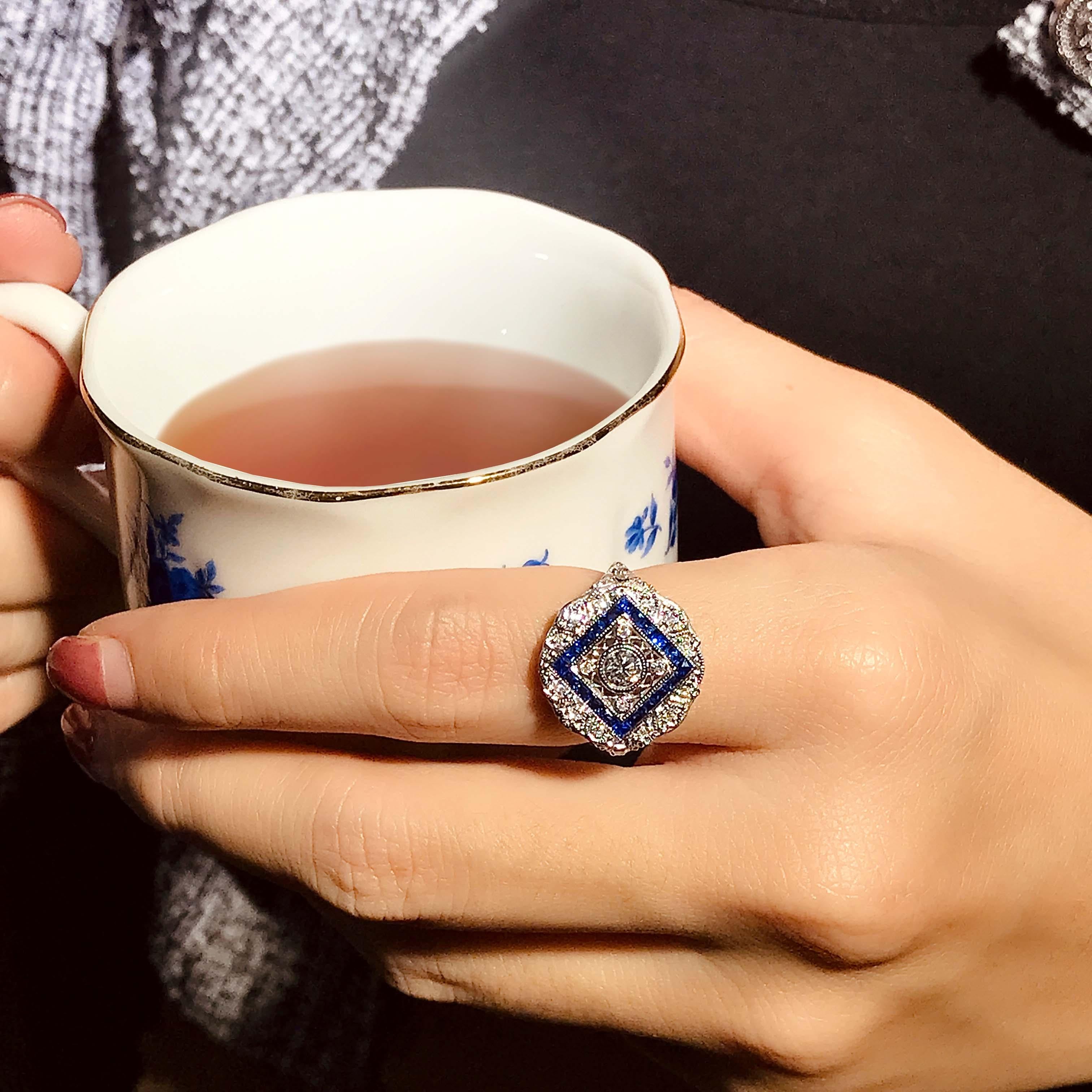An exquisite Art Deco style diamond and blue sapphire ring, crafted in 18k white gold. This stunning designed ring is encrusted with total of twenty-five round diamonds and twenty French cut blue sapphire, producing a beautiful and bold statement to