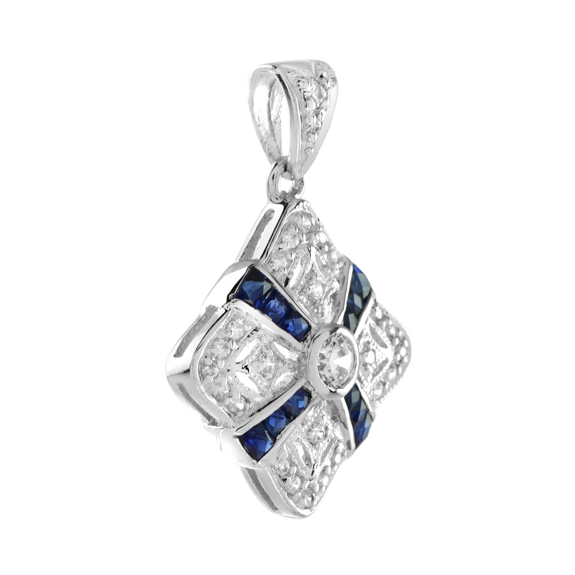 Inspired by the graceful symmetry of Art Deco design, this pendant features a round bezel-set diamond at its center, radiating timeless brilliance. Surrounding the diamond are meticulously arranged French-cut blue sapphires, forming a cross motif.