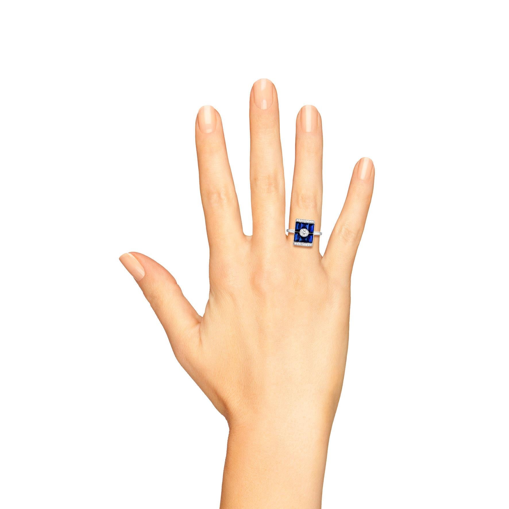 Art Deco design diamond and blue sapphire rectangular target ring in white gold. Centered with an estimated 0.25 carat diamond surrounded by eight calibre cut sapphires in visible settings and flanked with two horizontal rows of diamonds in grain