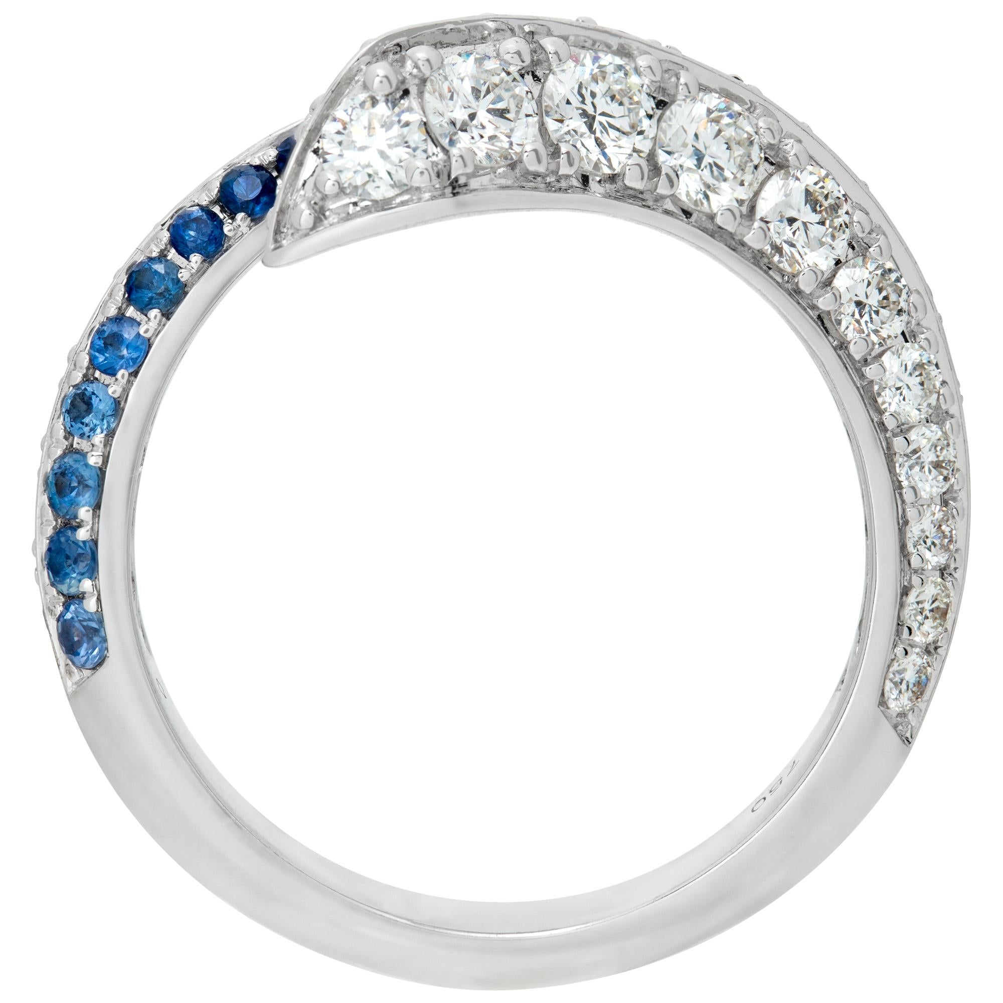 Women's Diamond and blue sapphire crossover ring in white gold. For Sale