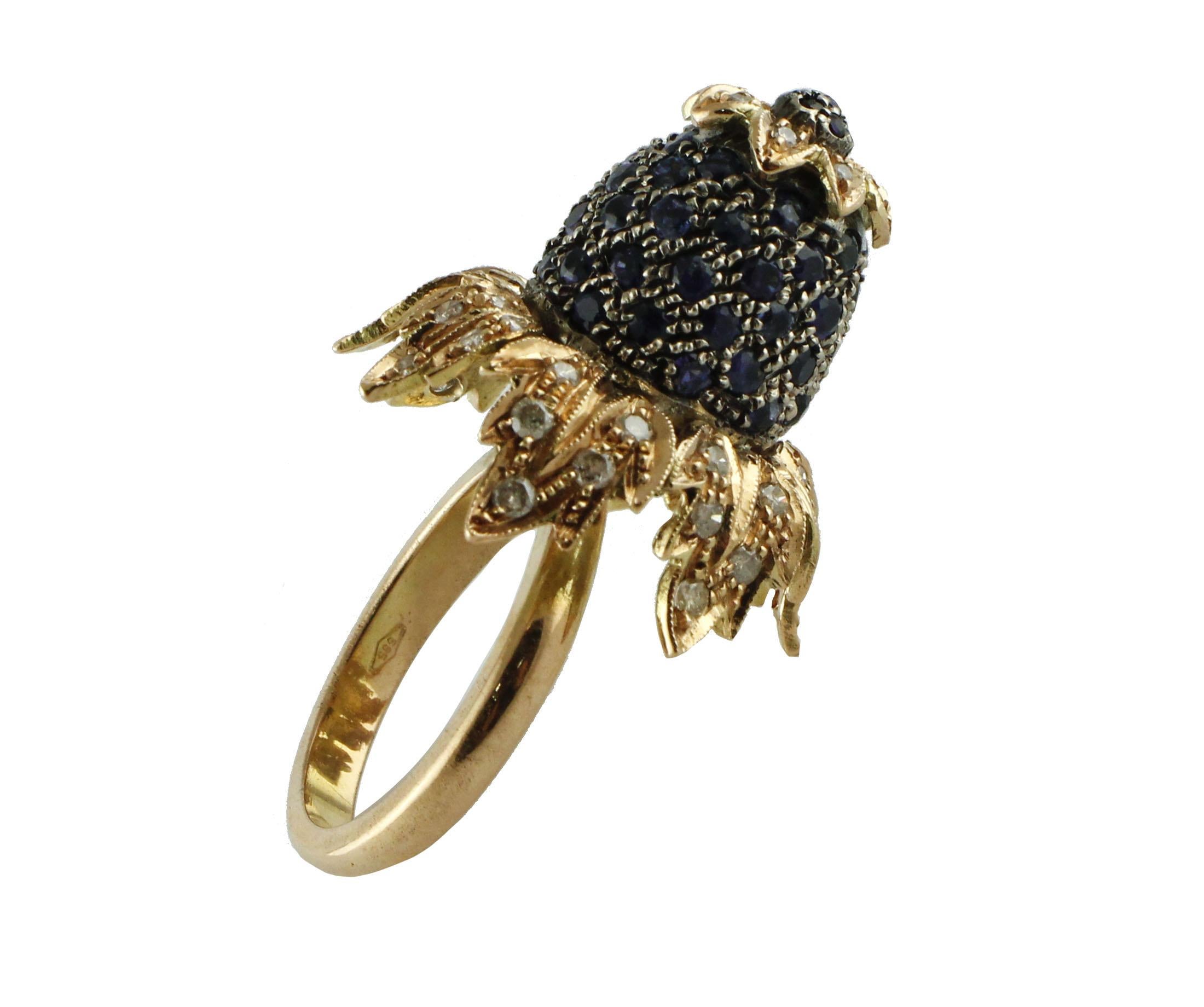 A particular flower shape is mounted in 14Kt gold with details in silver, the leaves are adorned of diamond and the flower's center (2.3 cm) is a high dome of blue sapphires 3.55 ct
Ring Size: US 7 - ITA 14,5 - French 54,5 - UK O
Diamonds 0.93