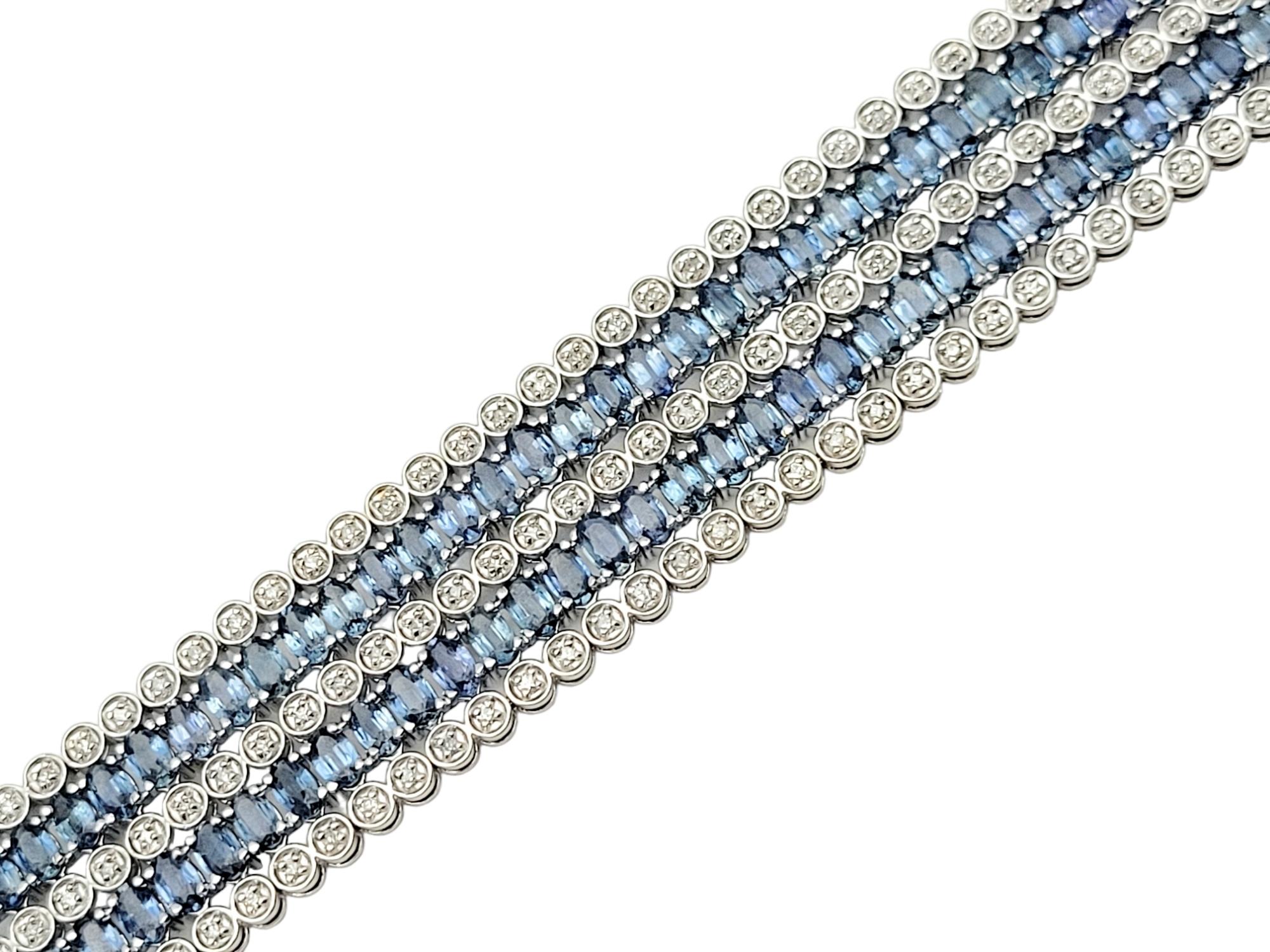 This enchanting cuff bracelet is a true testament to sophistication and style. Crafted from luminous 14 karat white gold, the bracelet boasts a timeless design that seamlessly combines the brilliance of diamonds with the rich allure of blue