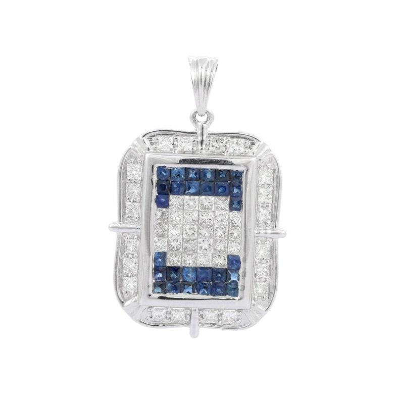 Statement Diamond Blue Sapphire Pendant in 18K Gold studded with round and baguette cut diamonds. This stunning piece of jewelry instantly elevates a casual look or dressy outfit. 
Sapphire stimulate concentration and reduces stress.
Designed with