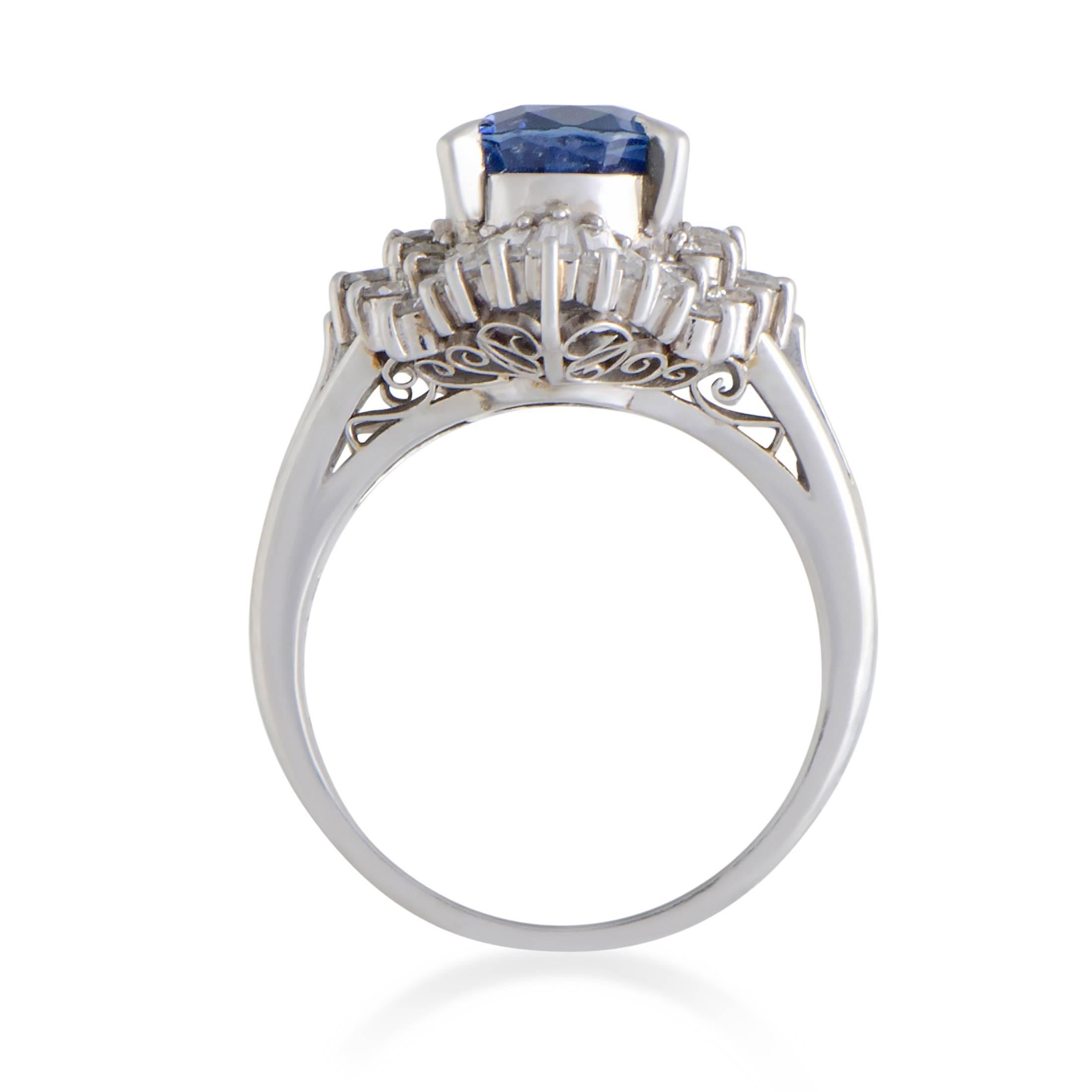 This ring offers a splendidly prestigious appearance thanks to its timelessly elegant design and tasteful blend of luxurious gemstones. The ring is made of platinum and boasts an eye-catching sapphire as the center stone, accompanied by a plethora