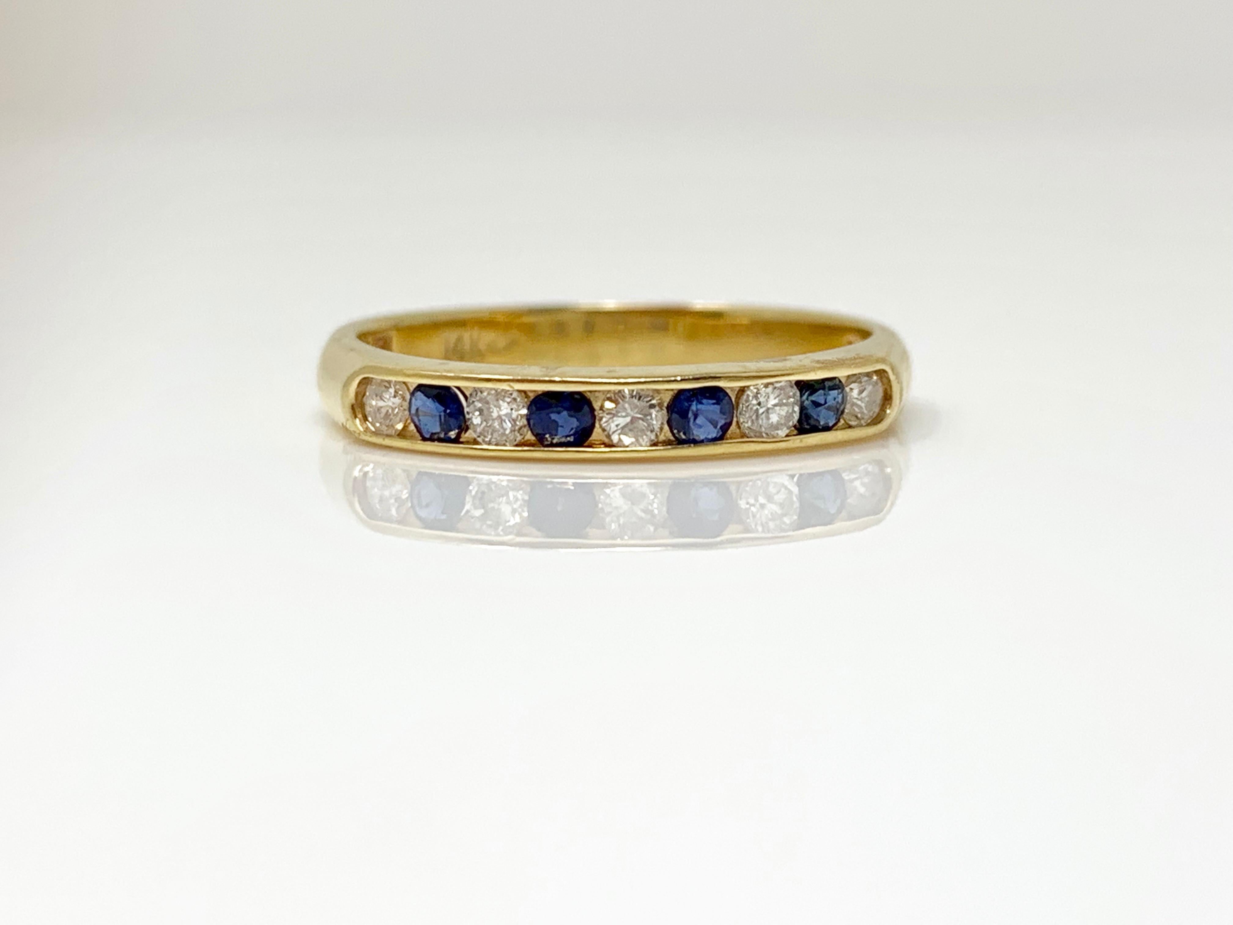 An elegant white diamond and blue sapphire wedding band. 
White Diamond weight : 0.15 carat 
Blue Sapphire weight : 0.20 carat 
Metal : 14k yellow gold 
Ring Size : 5 1/4 and is also available in size 6 and can be resized too in any size. 

