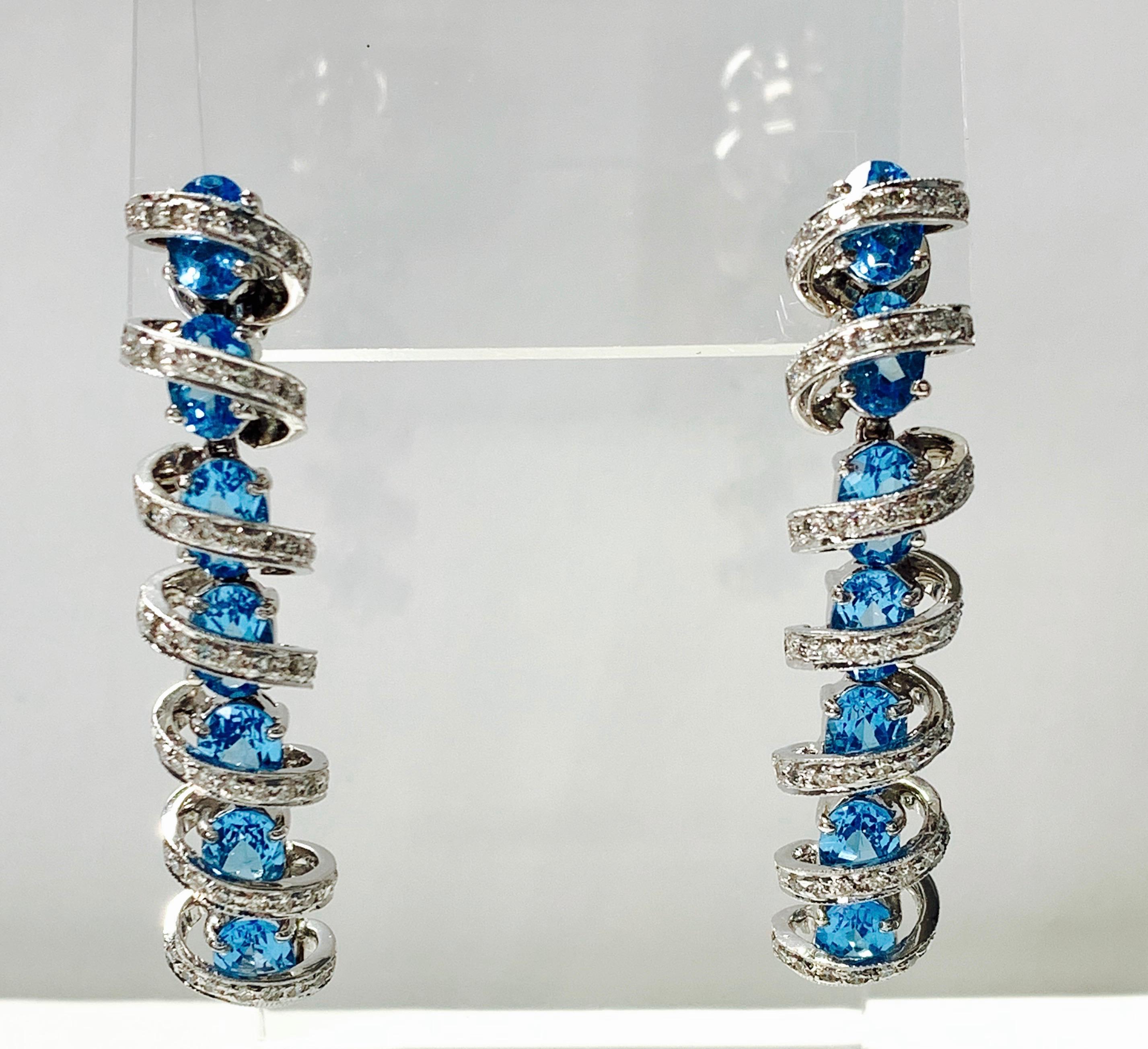Gorgeous Diamond and blue topaz earrings in 18k white gold. 
The details are as follows : 
Diamond weight : 1.75 carat ( GH color and VS clarity ) 
Blue topaz weight : 15 carat 
Measurements : length : 2 inches 
Metal : 18K white gold 
