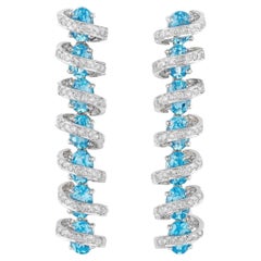 Boucles d'oreilles en or blanc 18 carats avec diamants et topaze bleue