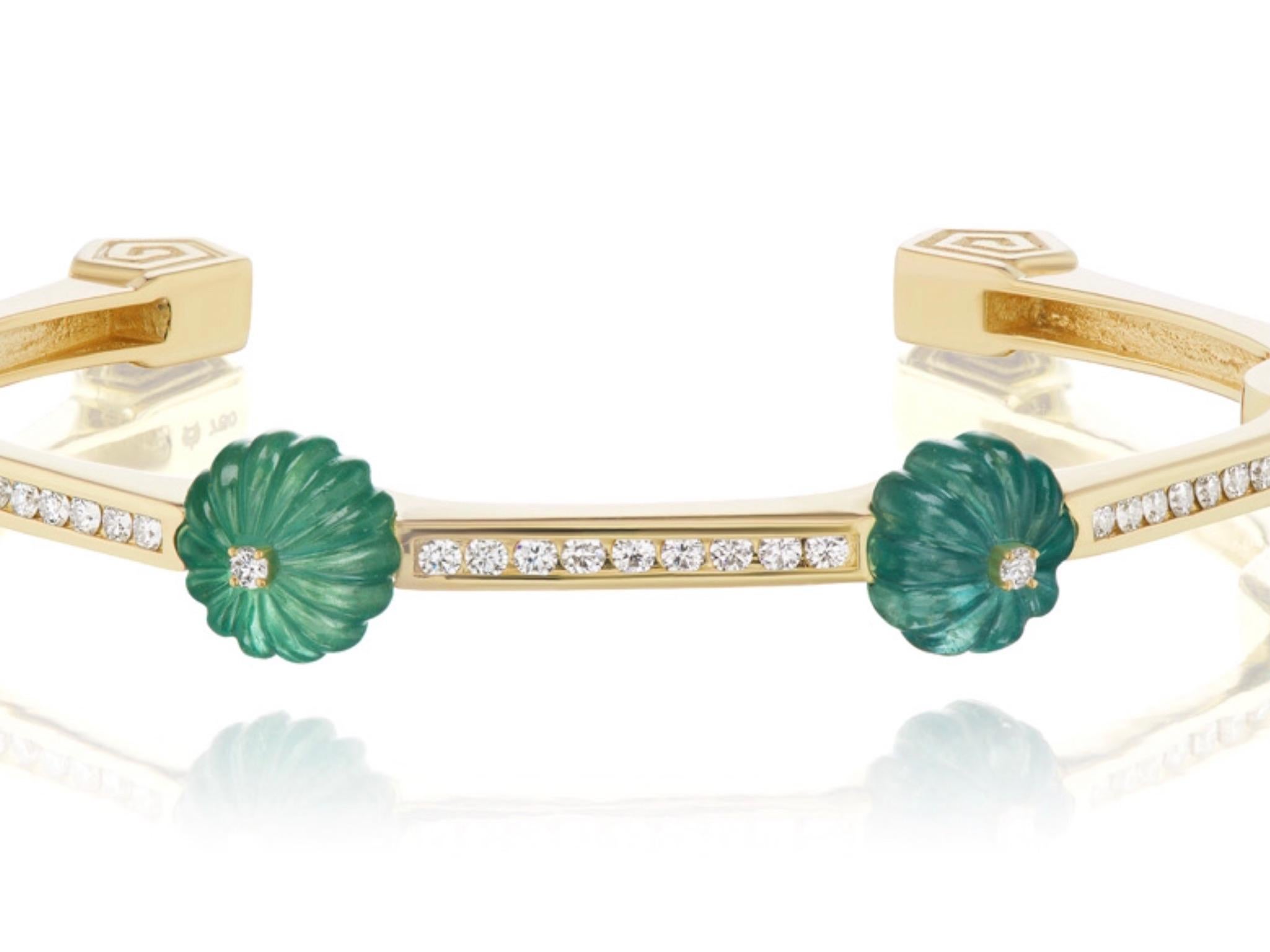 15.5 carats of Carved Emeralds makes up this new bracelet by Andrew Glassford. It contains .77 carats of G/H VSI round diamonds and is fashioned as a bangle with 45 degree angles all around the wrist ending in a scroll pattern at the base. On top of