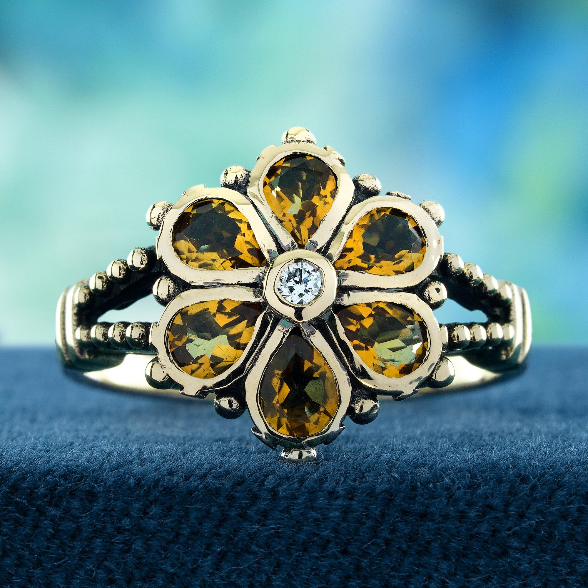 Features a brilliant diamond at the center, radiating timeless sparkle and elegance. Surrounding the diamond are vibrant citrines, arranged to resemble a blooming flower, their golden hues symbolizing warmth and vitality. The intricate floral design