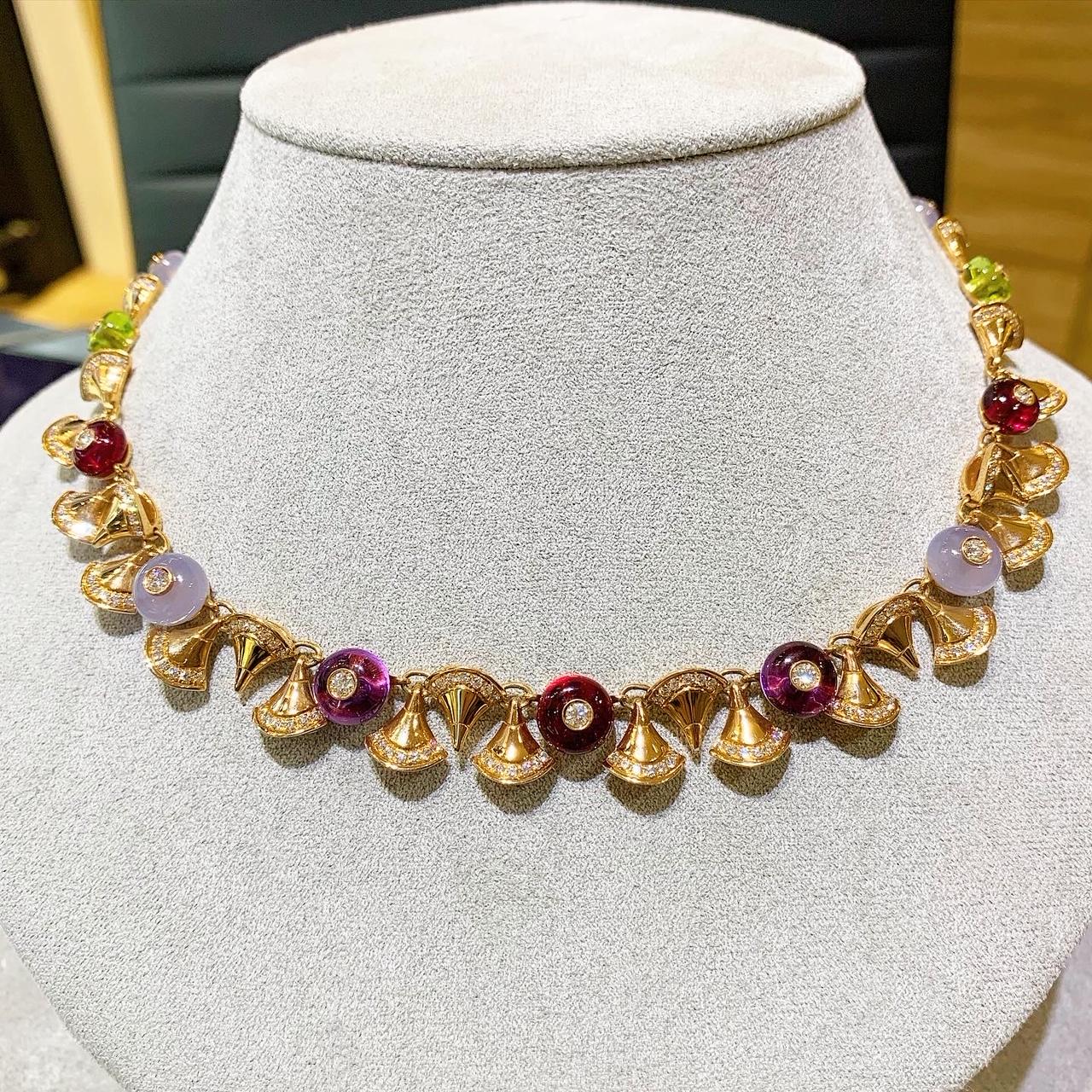 A stunning necklace created by Bvlgari and made in 18k rose gold with cone-shaped gold motifs set with brilliant-cut diamonds, polished amethyst, chalcedony, olivine, and rubelite beads inset with similarly cut diamonds. 
Diamonds estimated to weigh
