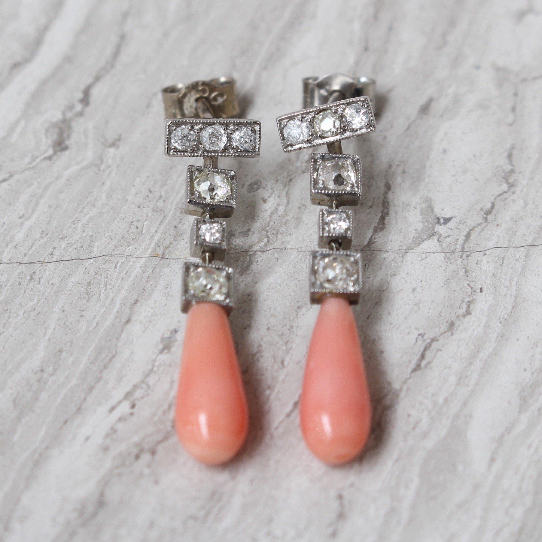 Pair of diamond and coral Art Deco 18-carat white gold earrings (circa 1950s). Art deco was revolutionary at the time it emerged and has withstood the test of time to remain highly fashionable. The trend has proven its longevity and its timeless