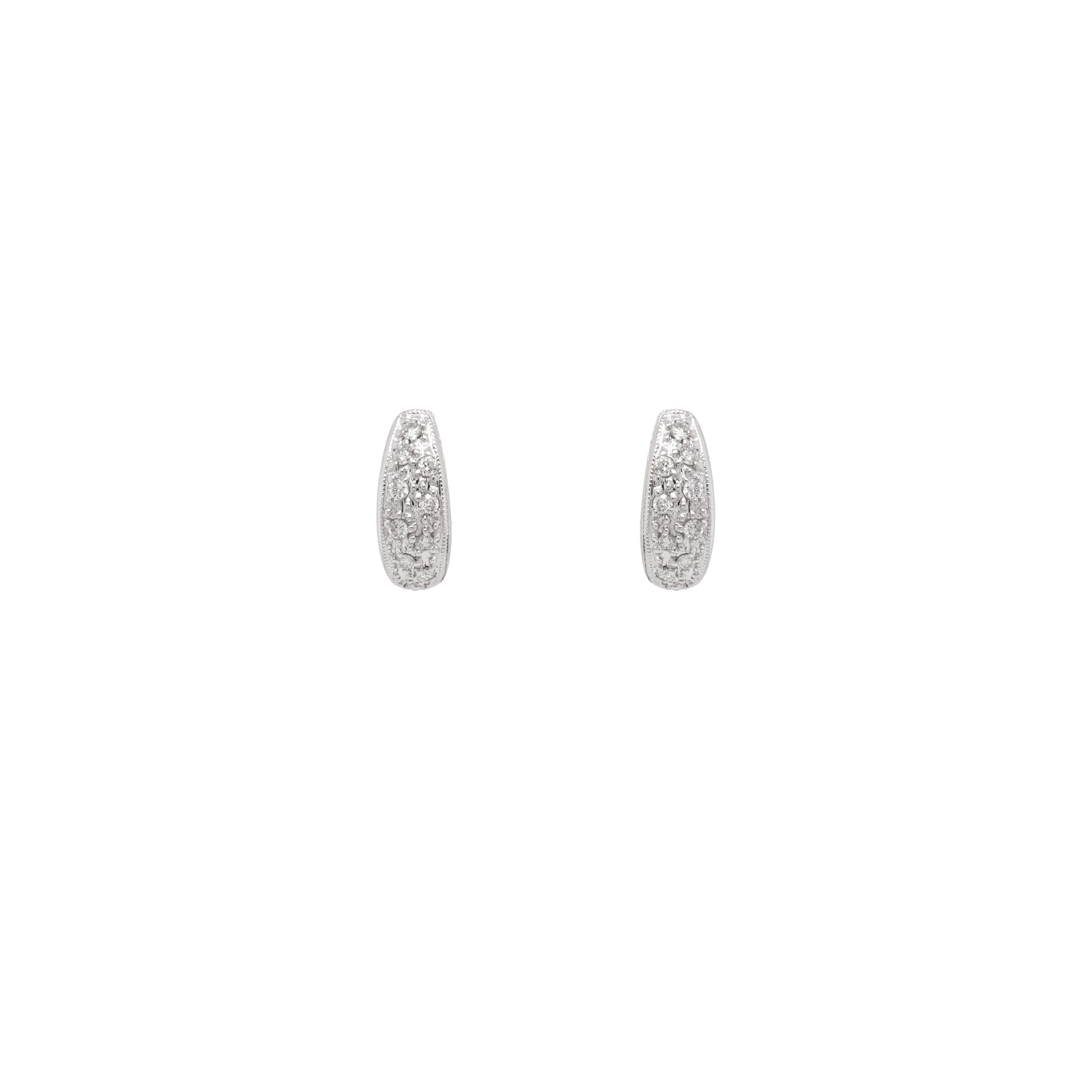 These wonderful drop earrings are masterfully crafted from luxurious 18 carat white gold, exhibiting a sophisticated and elegant design.

Effortlessly transitioning from day to night, these fantastic earrings feature a small huggie hoop, pavé set