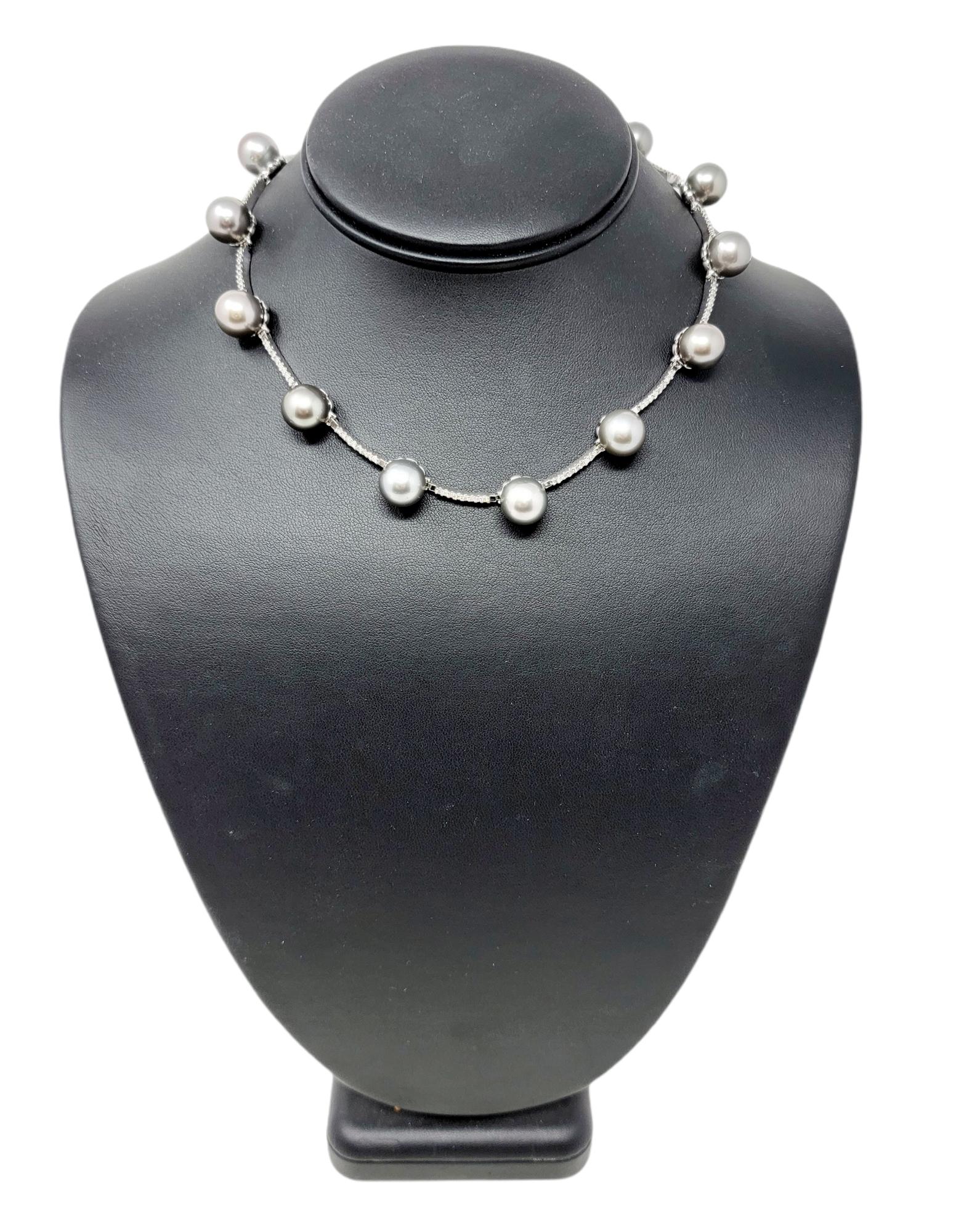 Contemporary diamond and pearl station necklace will make an elegant statement on the neck. The diamond encrusted bar links paired with the stunning silver pearls is truly a sight to see. It features 14 cultured Tahitian pearls in a gorgeous silver