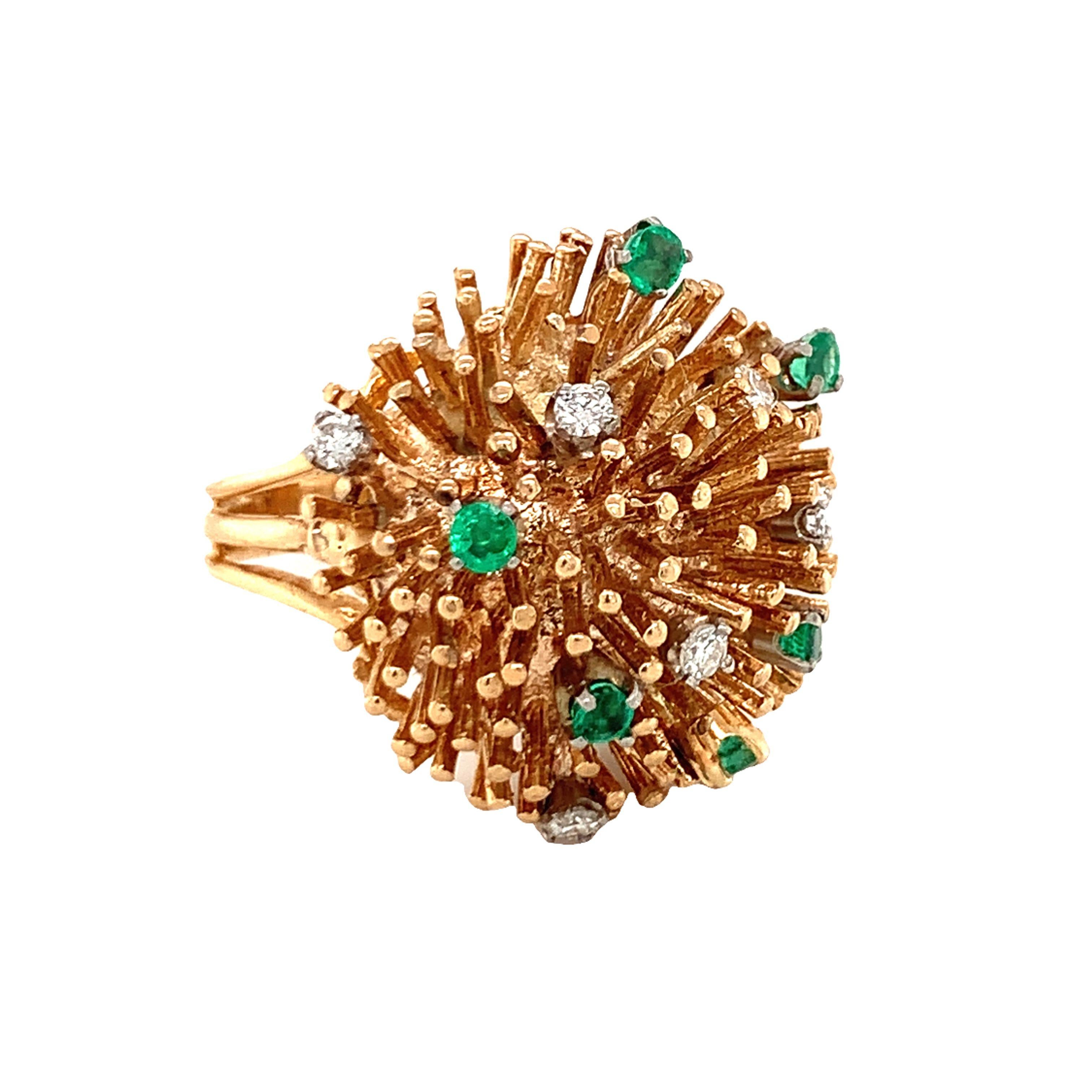 One diamond and emerald starburst design 14K yellow gold ring featuring six round brilliant cut diamonds weighing 0.40 ct. with G color and VS-1 clarity. Accented by six round brilliant cut emeralds weighing 0.50 ct. Circa 1970s.

Flash, pointed,