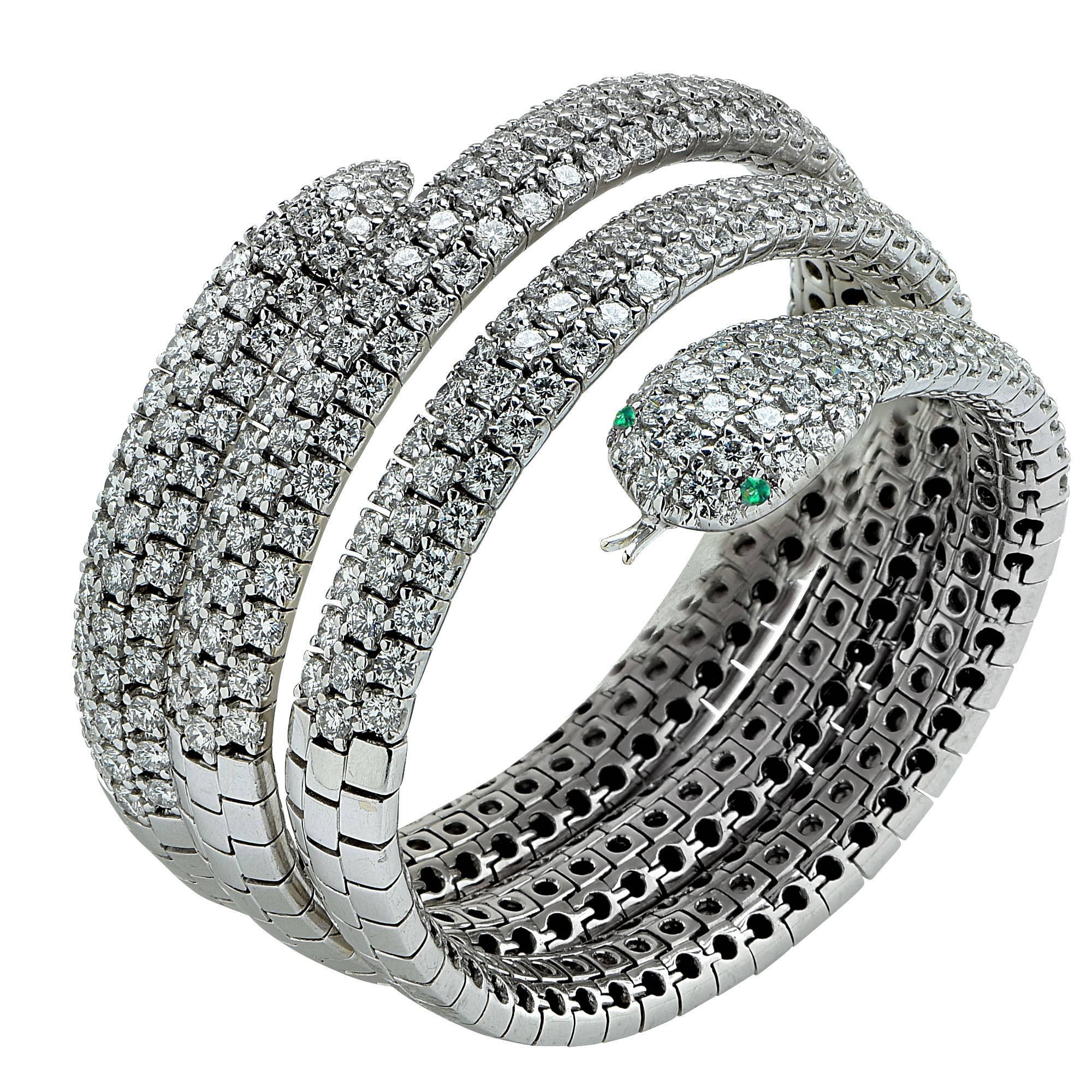 Feast your senses on this superbly crafted 18k white gold snake bangle adorned with round brilliant cut diamonds weighing approximately 24cts total, G color VS clarity. This superb bracelet glides over your wrist and envelopes it in silky smooth
