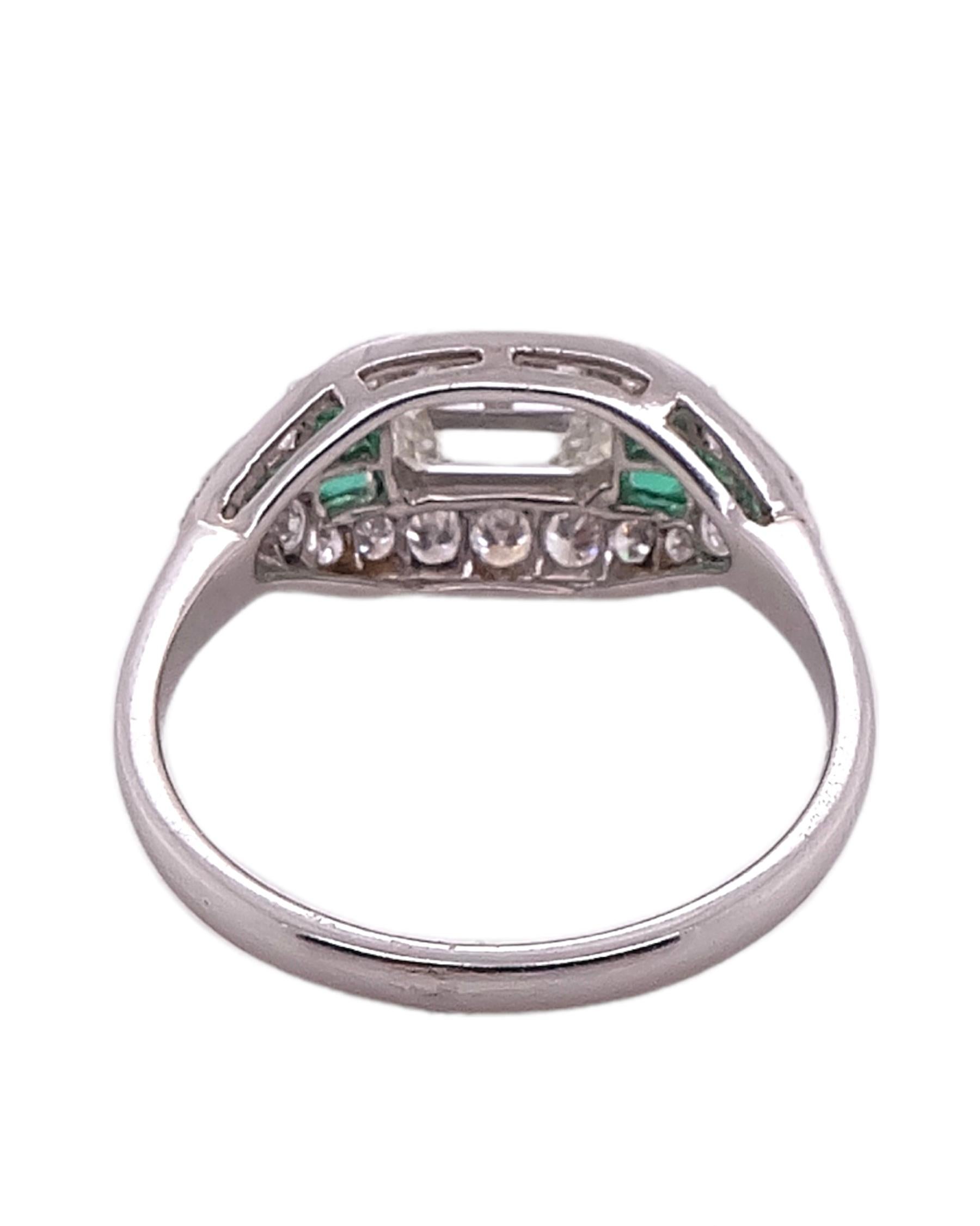 A Stunning Art deco style Diamond and Emerald ring by Sophia D that features a 0.78 carats of emerald cut center stone complemented with 0.37 carat small diamonds and 0.42 carat emerald stones. 

Sophia D by Joseph Dardashti LTD has been known