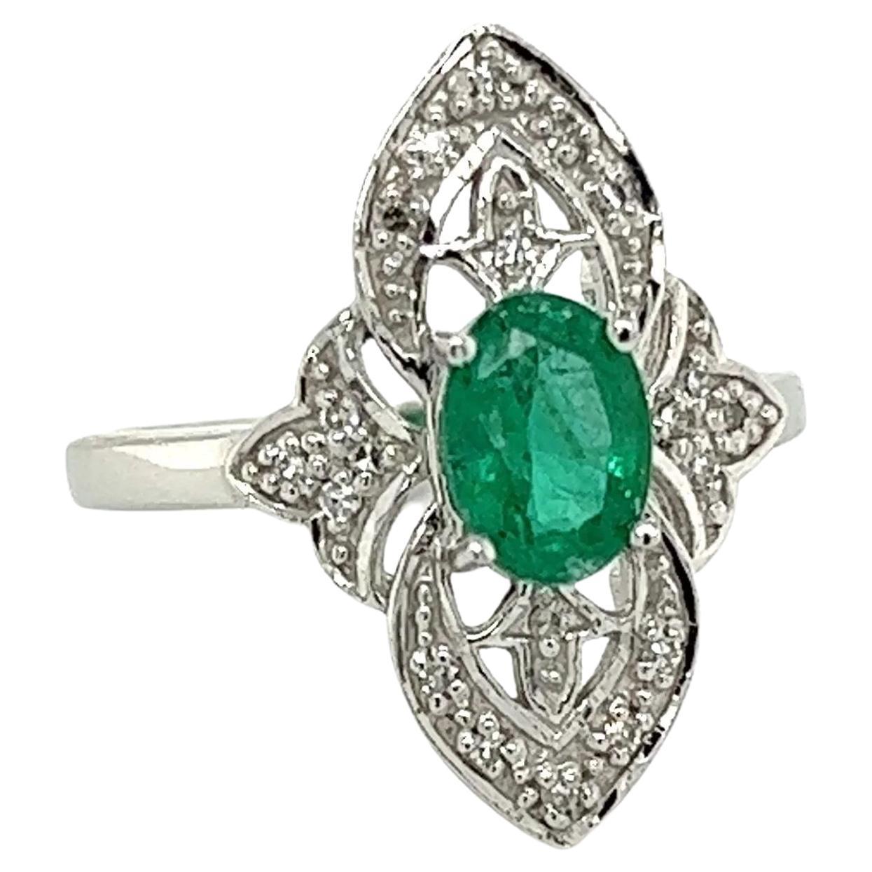 Simply Beautiful! Finely detailed Art Deco Revival Diamond and Emerald Gold Navette Cocktail Ring. Centering a securely nestled Oval Emerald, approx. 0.55 Carat, surrounded by Diamonds, approx. 0.09tcw. The ring is Hand crafted in 18K White Gold.