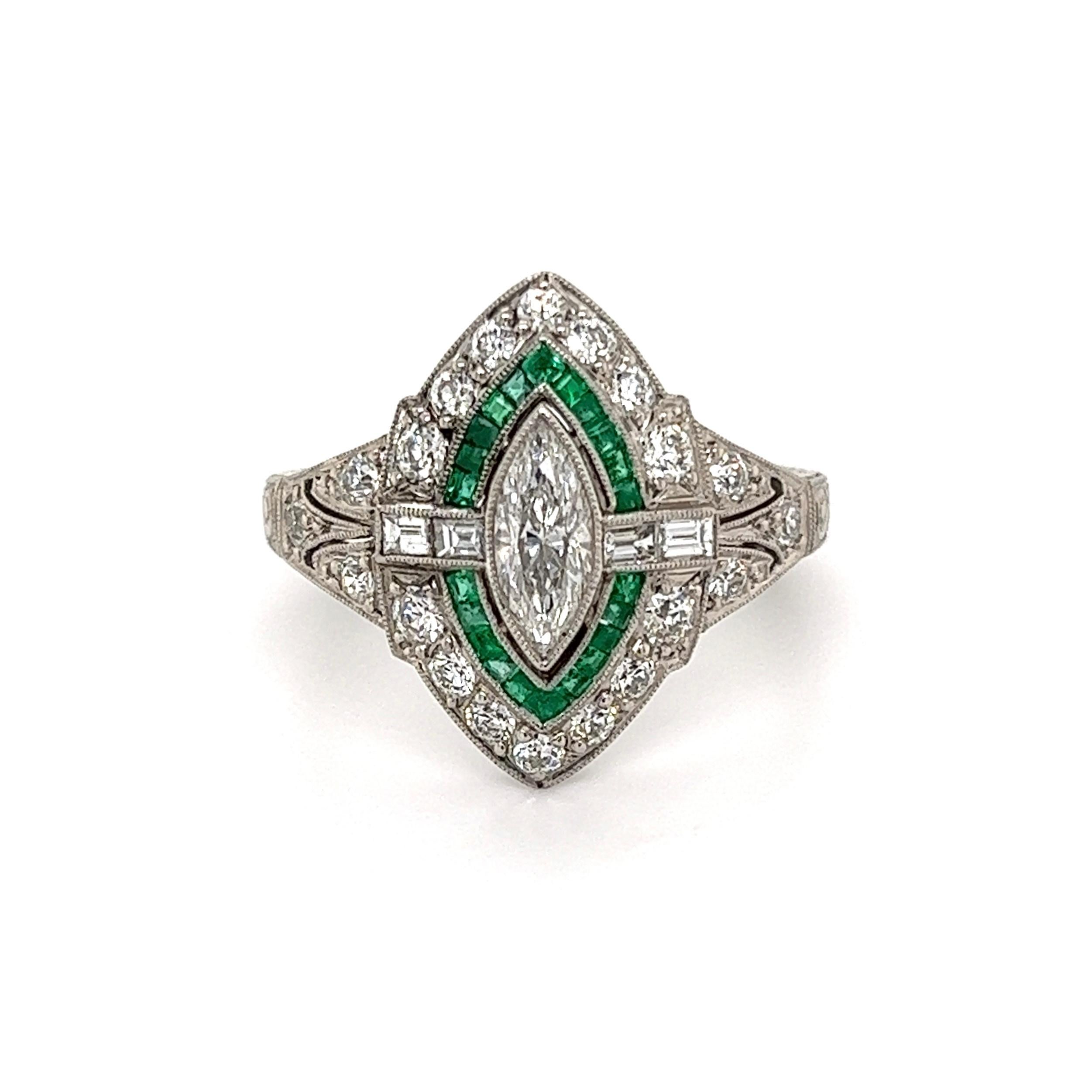 Simply Beautiful! Finely detailed Art Deco Revival Platinum Cocktail Ring, centering a securely nestled Marquis Diamond, approx. 0.48 Carat, accented by Diamonds, approx. 0.77tcw and Emeralds, 0.70tcw Enhancing the hand engraved shank are Diamonds.