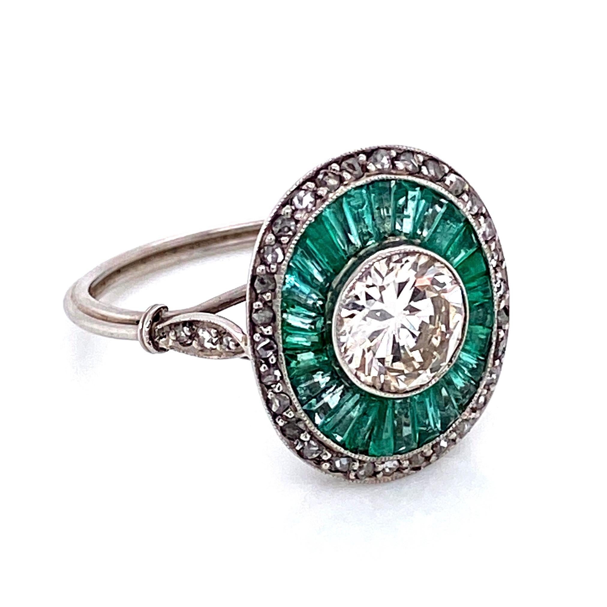 Beautiful Solitaire Cocktail Platinum ring. The center securely set with a 7mm Transitional cut diamond, weighing approx. 1.35 carat; surrounded by long light emerald baguettes approx. 1.50 total carat weight and 0.36tcw side diamonds. Handmade