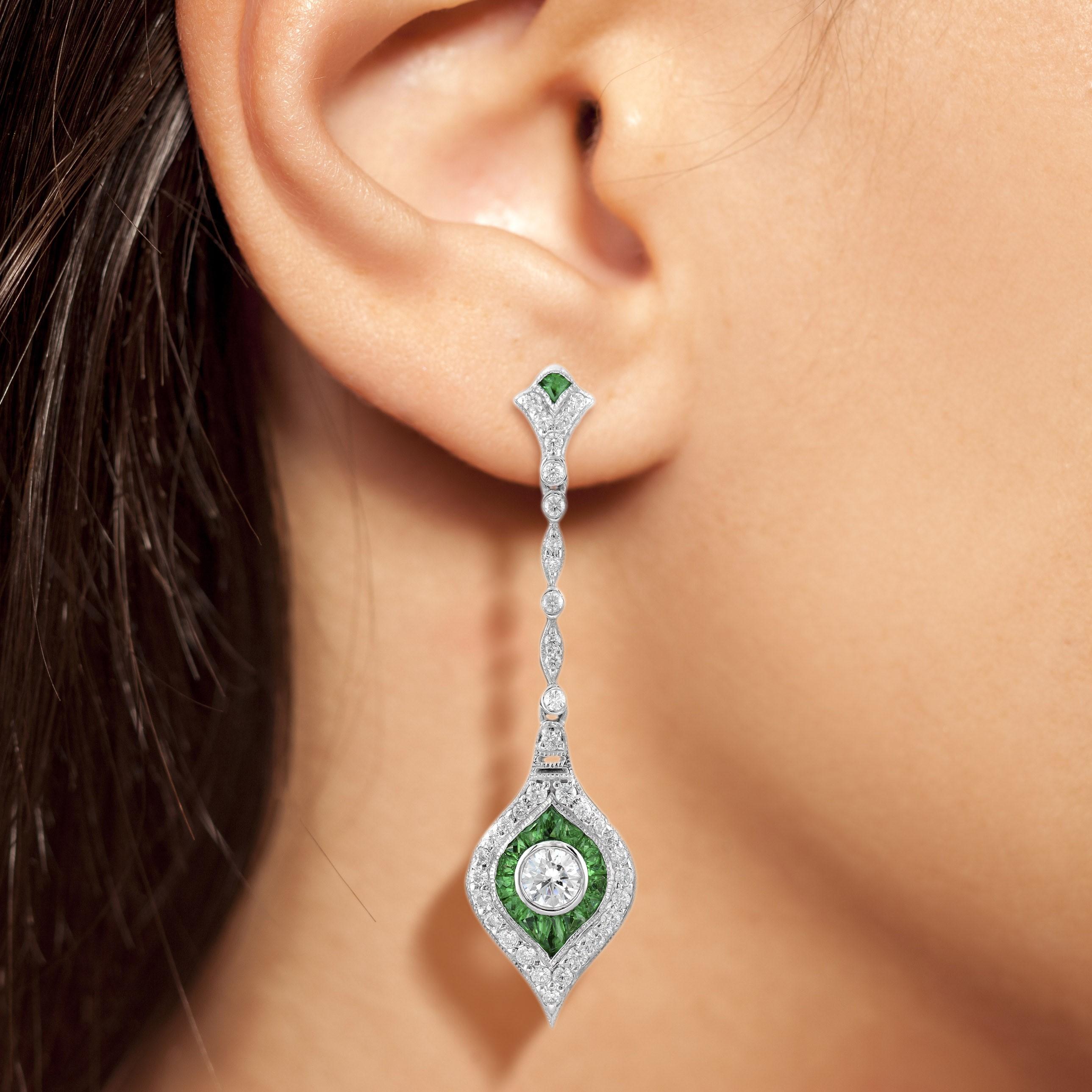 These long dangle earrings will elongate your face shapes and complements your features! They encompass 0.50 carats of round brilliant center diamonds, 2.04 carats emerald and 0.76 carats accents diamonds all set in 14k white gold.

Earrings