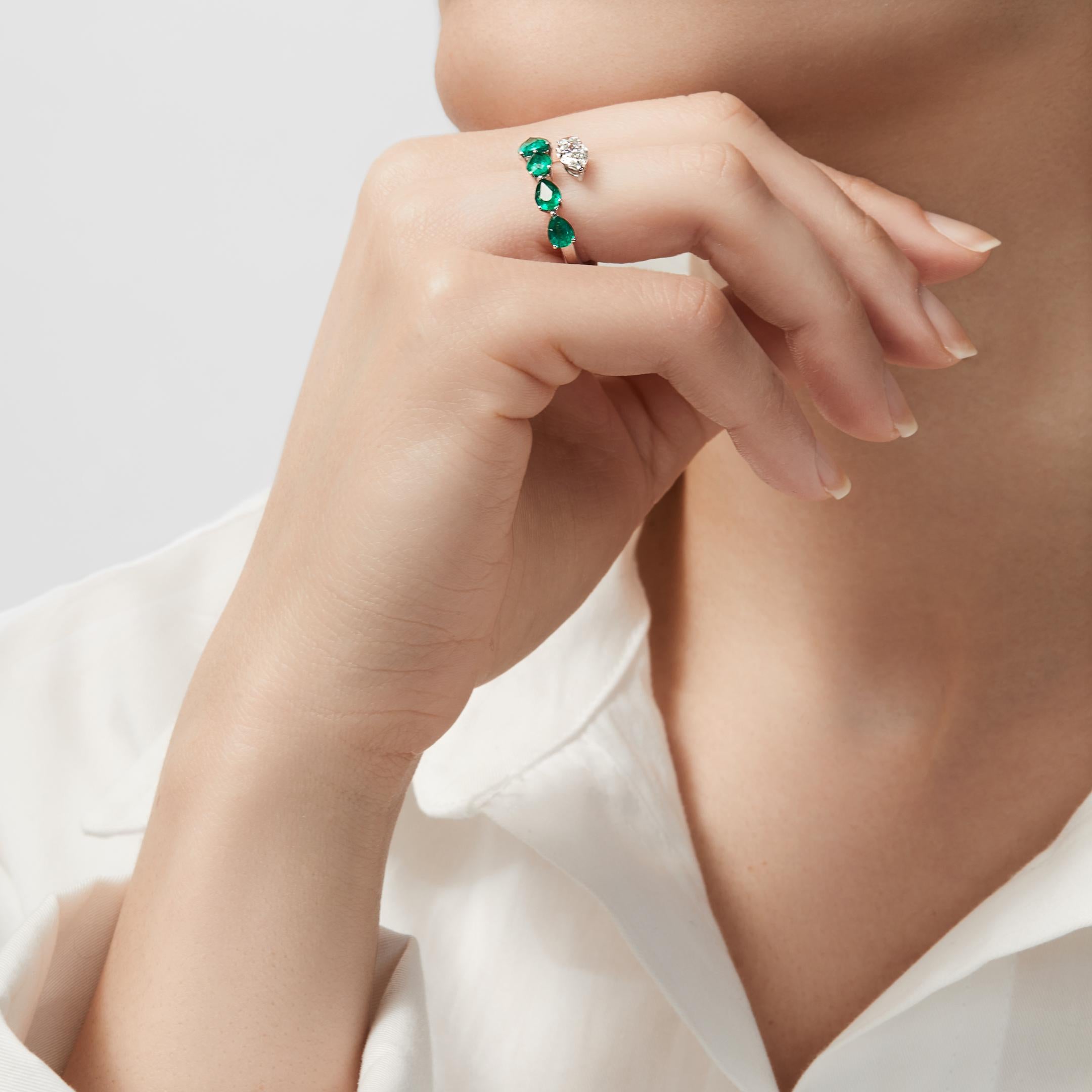 Your perfect accessory awaits in the Emerald and Diamond Bypass Ring. This chic bypass ring embraces the finger with a line of pear-shaped white diamonds that faces a row of pear-shaped gemstones. The emerald ring’s open design is fashion-forward,