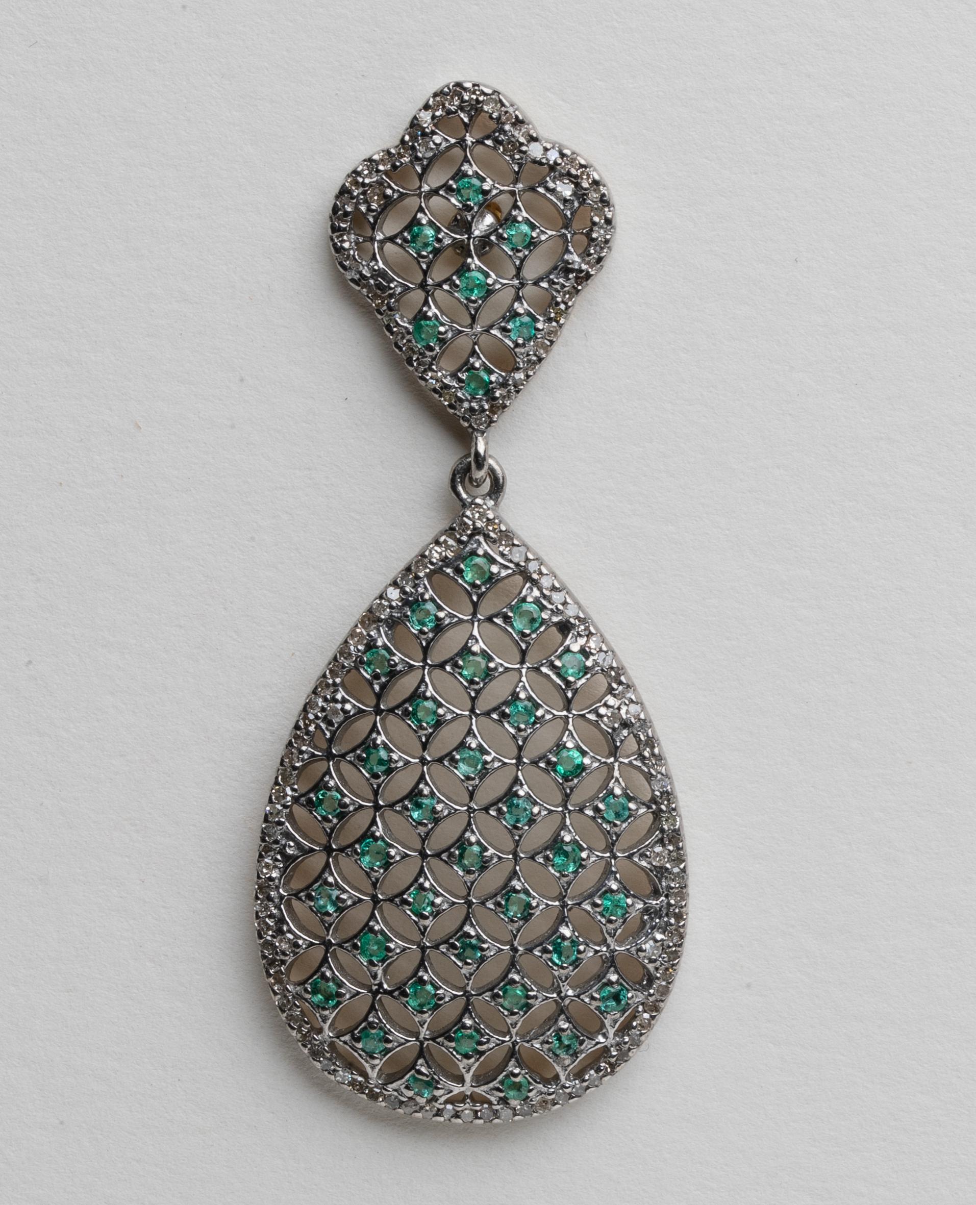 A pair of lovely lattice-work earrings with round faceted emeralds bordered with round, brilliant cut diamonds in a pave` setting.  Set in sterling silver, post is 18K gold for pierced ears.