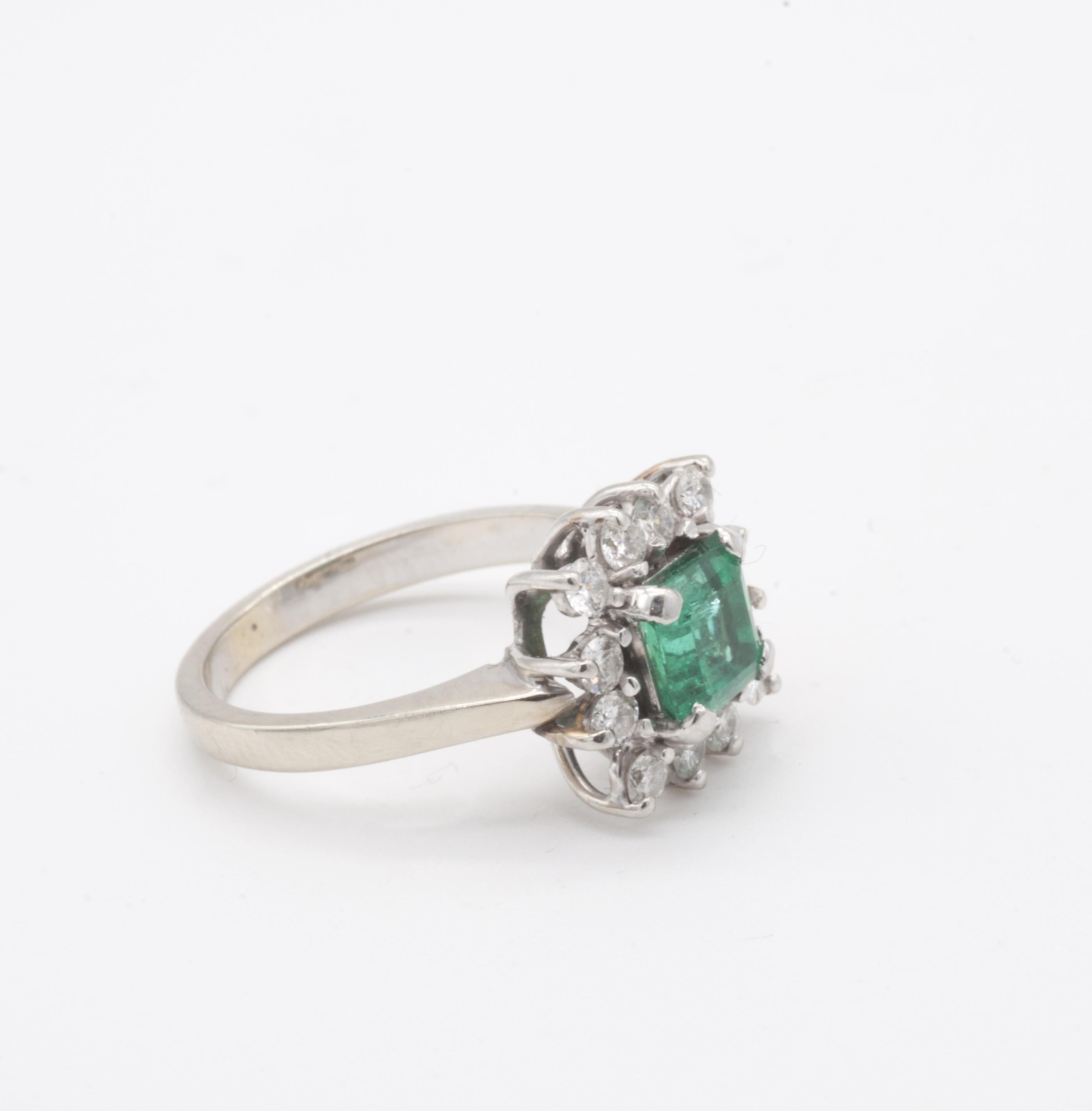One stamped ladies Emerald and Diamond cocktail ring with approximately 1ct Emerald (6 x 6mm) and 12 brilliant diamonds. 