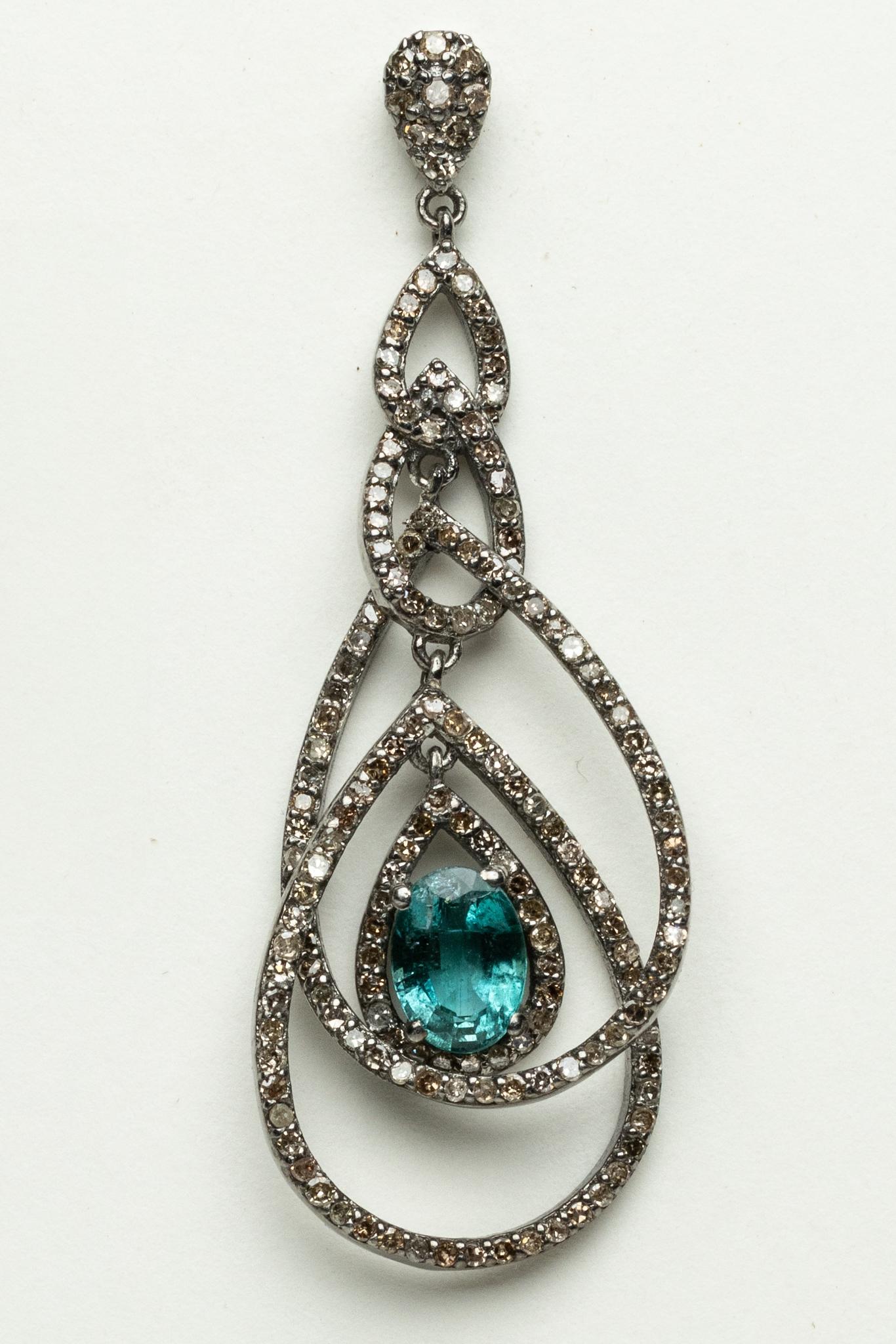 Pair of double loop dangle earrings comprised of pave`-set diamonds with faceted, oval emeralds at the center.  18K gold post for pierced ears.  Diamonds total 1.71 carats and the emeralds total 1.82 carats.

