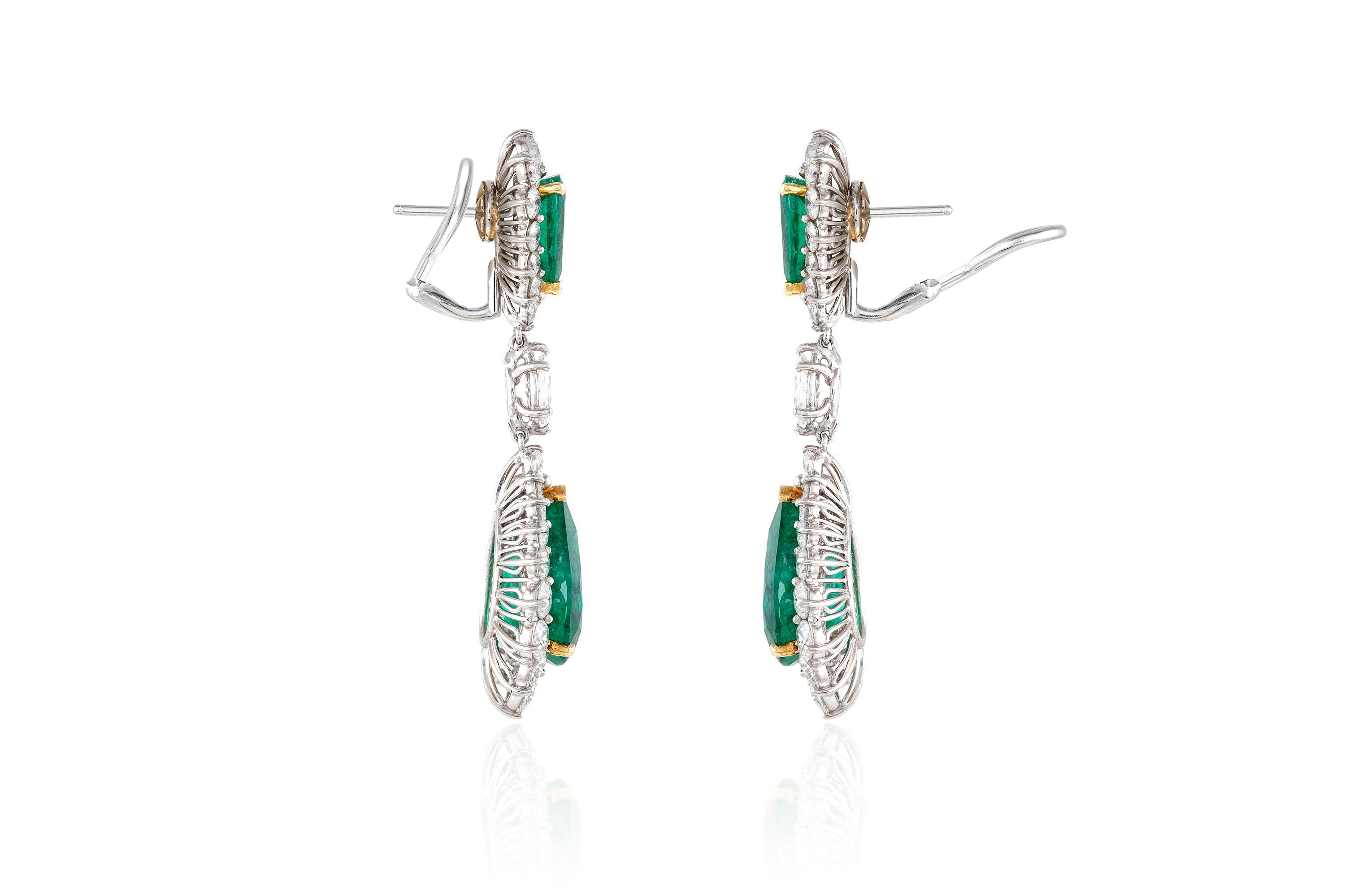 Finely crafted in platinum and 18k yellow gold with four Pear-Shaped Brazilian Emeralds.
The two AGL certified bottom Emeralds weigh 6.72 and 6.38 carats, the top Emeralds weigh 1.59 and 1.33 carats.
The earrings feature Round Brilliant and Marquise