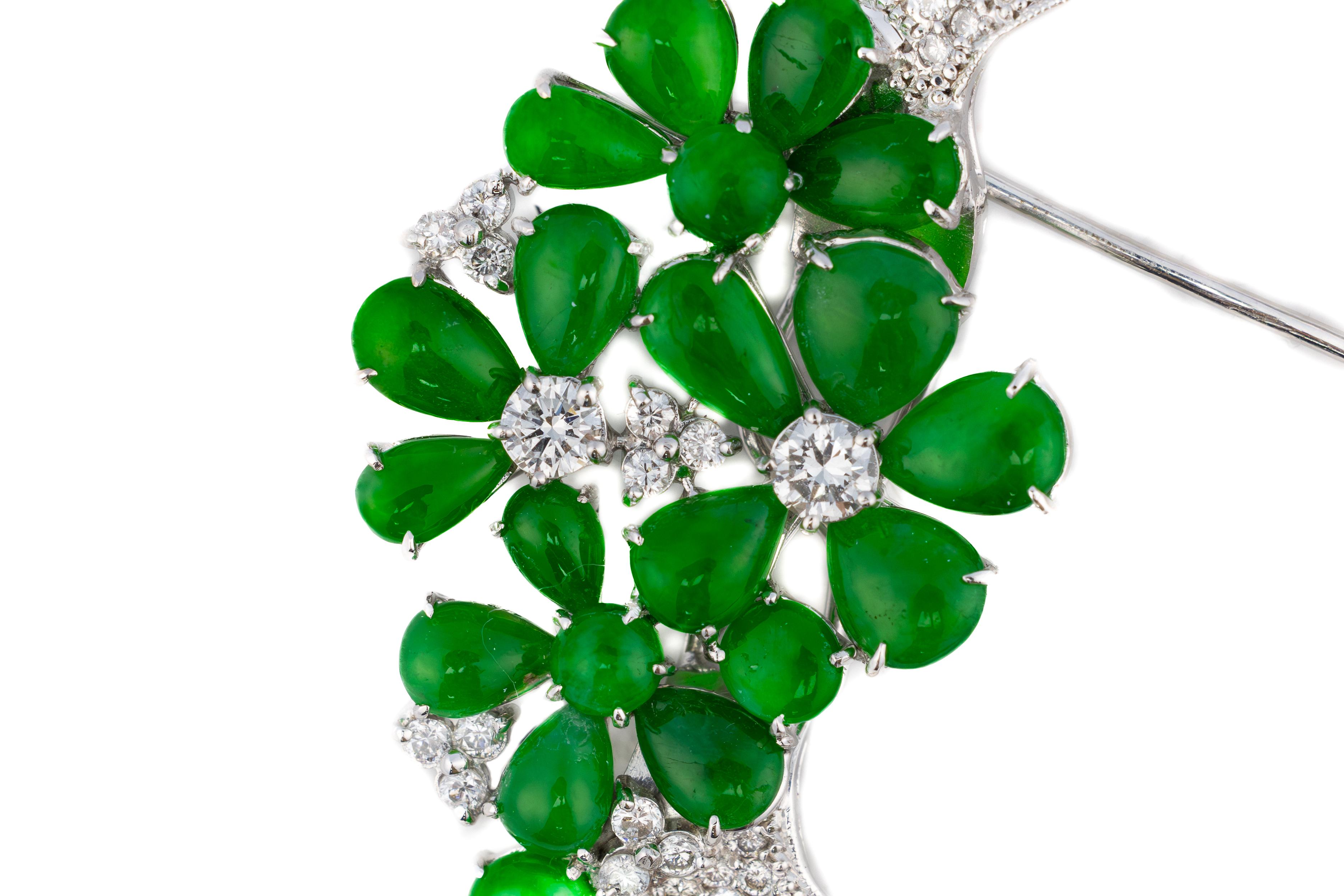 Diamond and Emerald Floral Brooch

A mesmerizing blend of sophistication and artistry, this brooch is a masterpiece of fine jewelry design. Set in luminous white gold, the piece showcases an exquisite arrangement of lush green emeralds, cut into
