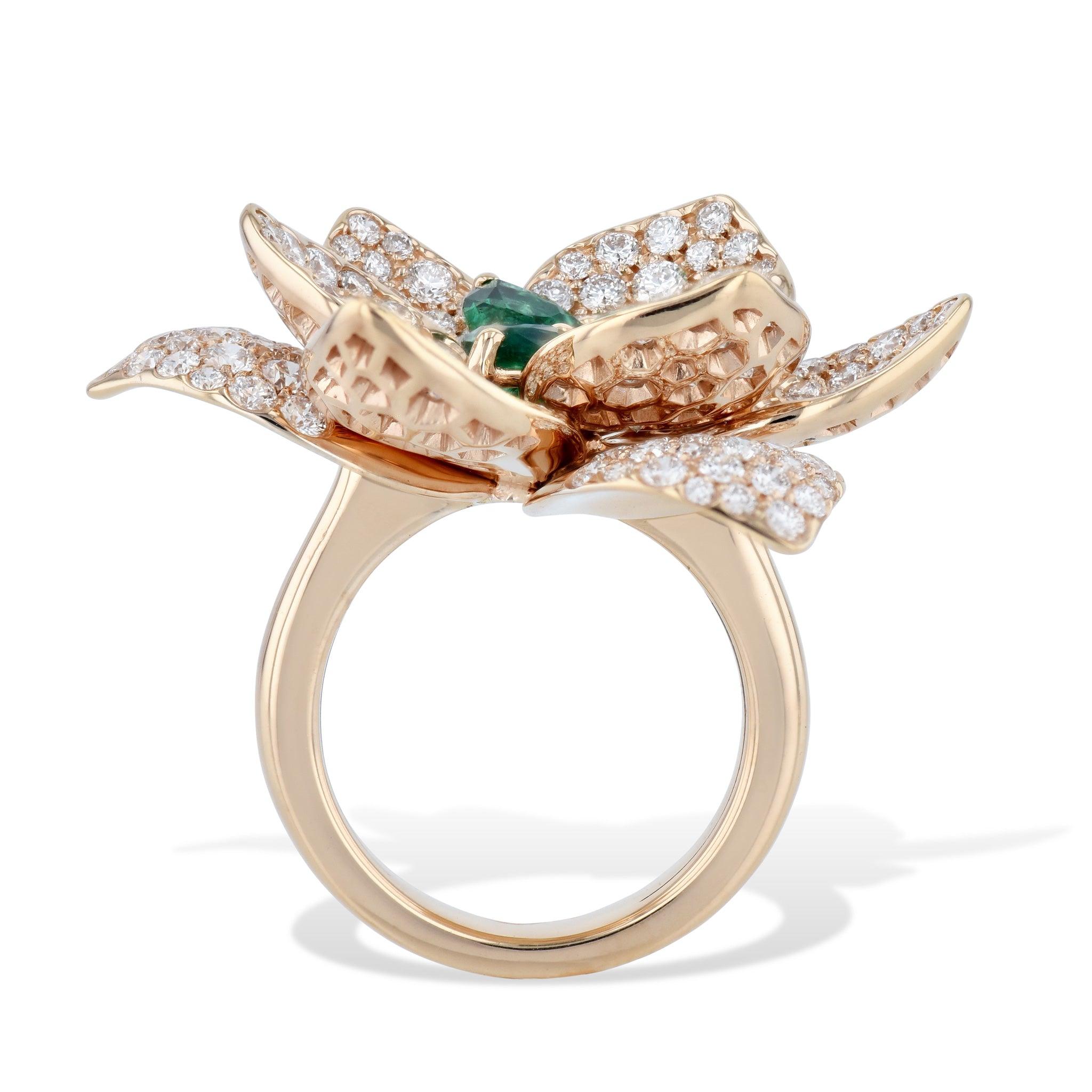 
This beautiful rose gold diamond and emerald flower ring is sure to dazzle!
The center holds a breathtaking pear-shaped emeralds totaling 1.78 carats, pear shaped. 
These are surrounded by diamond pave pedals. 
Rose Gold Diamond and Emerald Flower