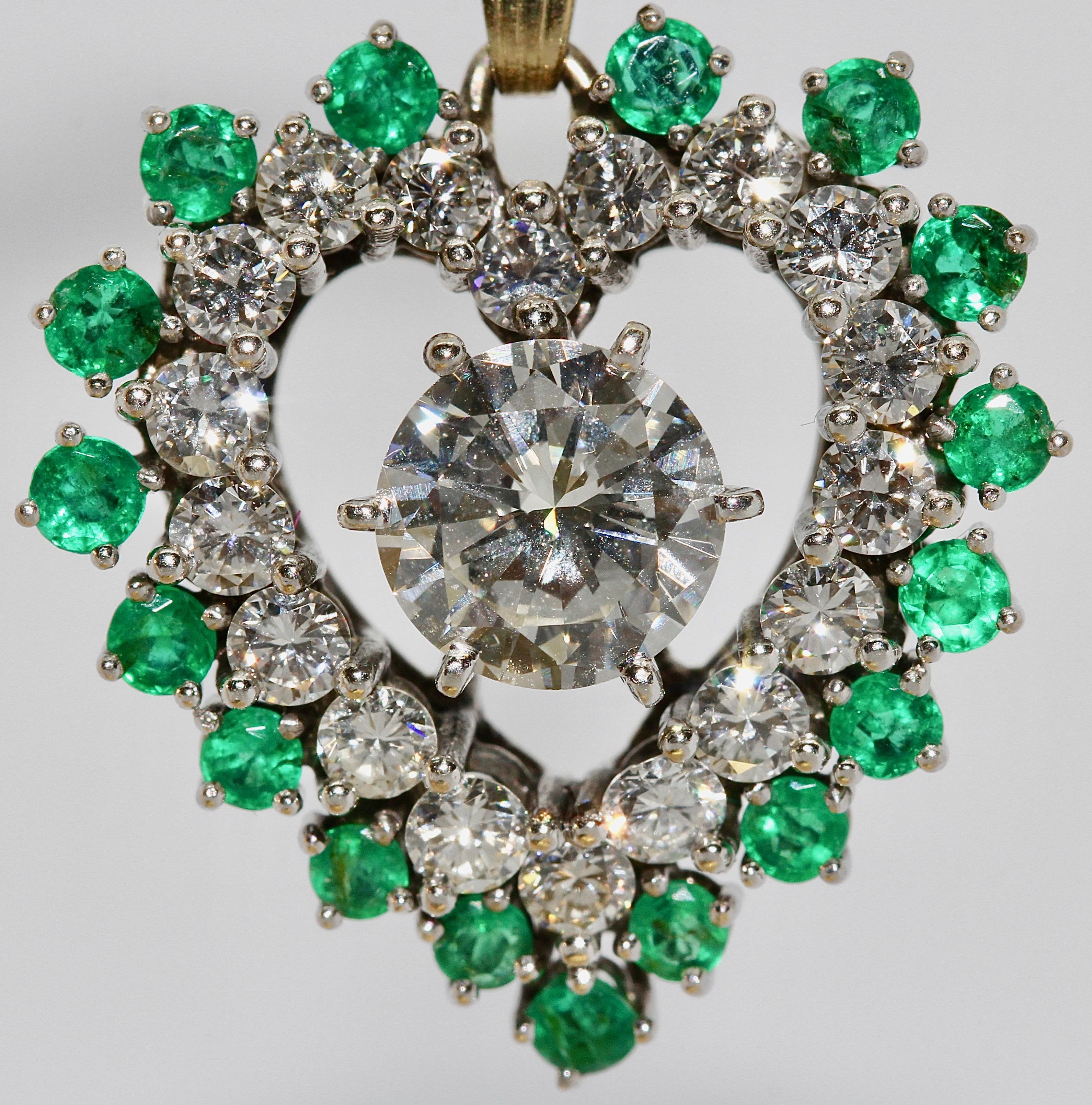 Dreamlike Diamond and Emerald Heart Pendant. 18 Karat Gold with Large Solitaire.

The large solitaire has a size of almost 1.4 carat. VVS1, color Top Wesselton.

The 18 small diamonds have a total weight of about 1.2 ct.

The clarity of the small
