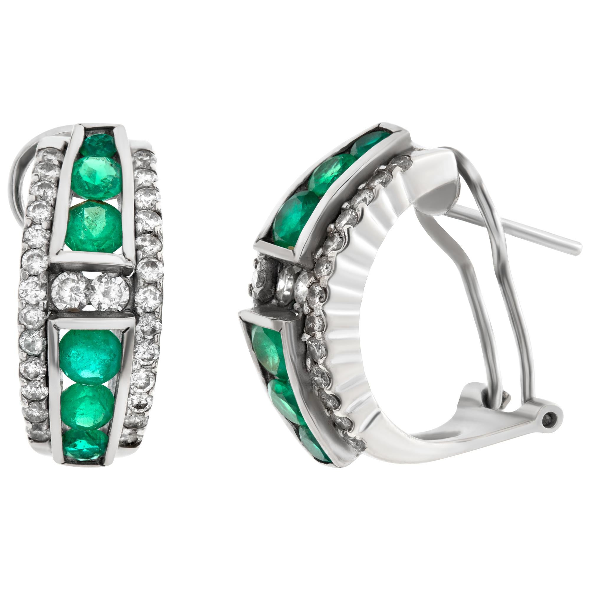 Diamond and Emerald huggie earrings in 18k white gold with omega clip backs. Approximately 0.42 carat in diamonds and 1.28 carat in round emeralds. Measures 20mm x 8mm.
