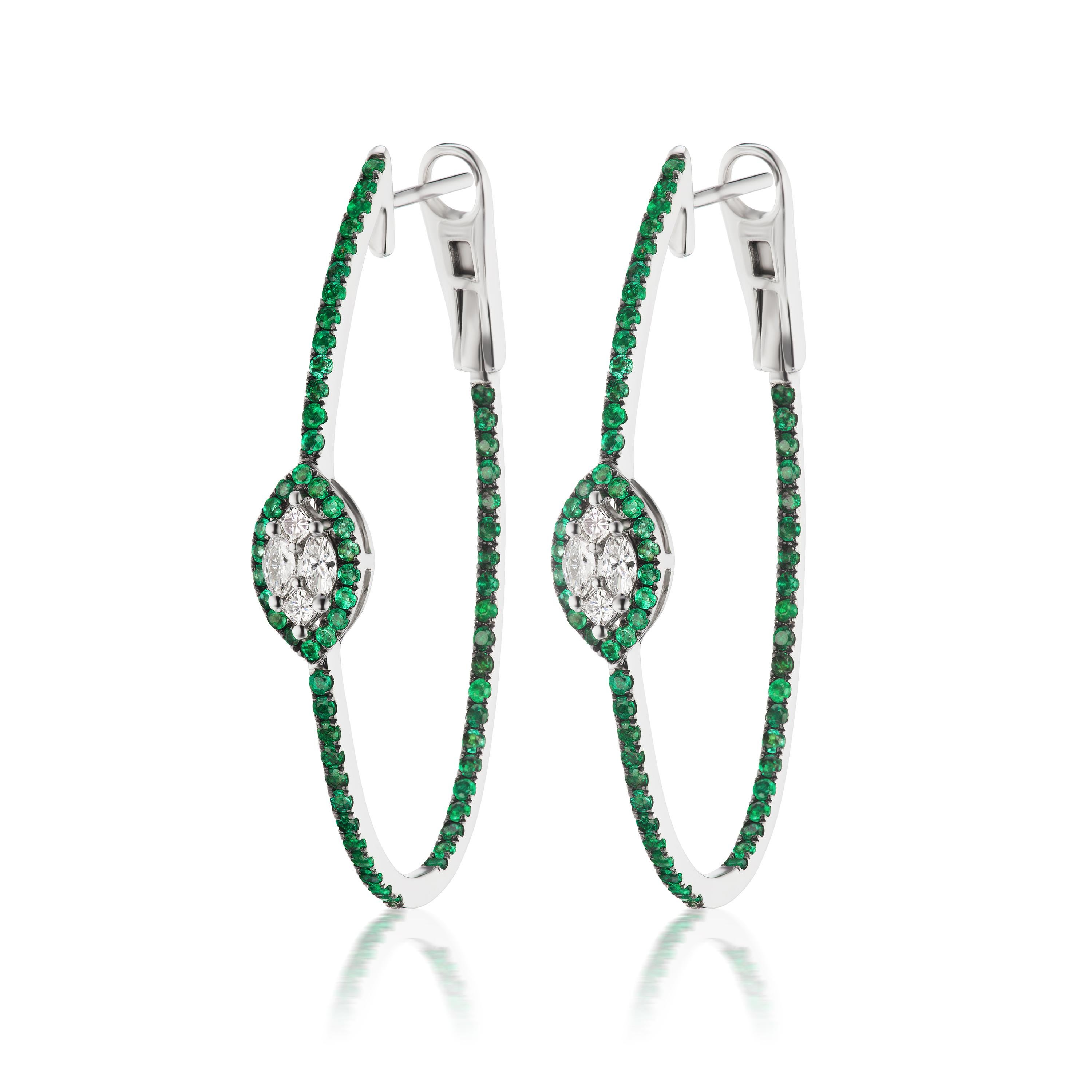 A glamorous fusion of emeralds and diamonds. This inside-out hoop earring features a marquise motif of diamonds accentuated by a halo of emeralds around it. Pave emeralds are studded inside-out of this hoop earring to give it a mesmerizing look. 