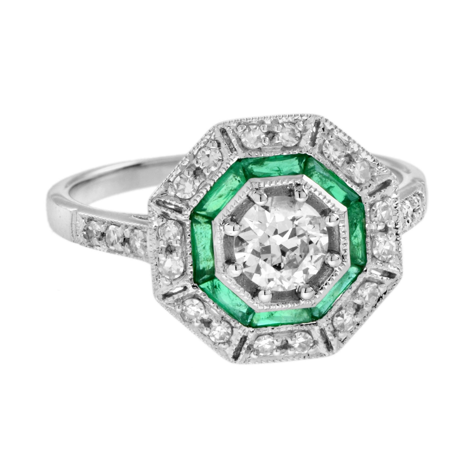 An 18k white gold Art-Deco design diamond and emerald target ring, center diamond with an outer ring of round diamonds an inner one of French cut emeralds and finished with millgrain edging, finished with diamond shoulders.

Ring Information
Style: