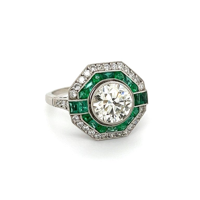 Simply Beautiful! Elegant and finely detailed Sapphire and Diamond Art Deco Revival Cocktail Ring. Center Hand set with a securely nestled 1.88 Old European-Cut Diamond surrounded by Emeralds, weighing approx. 1.20 total Carat weight and around the