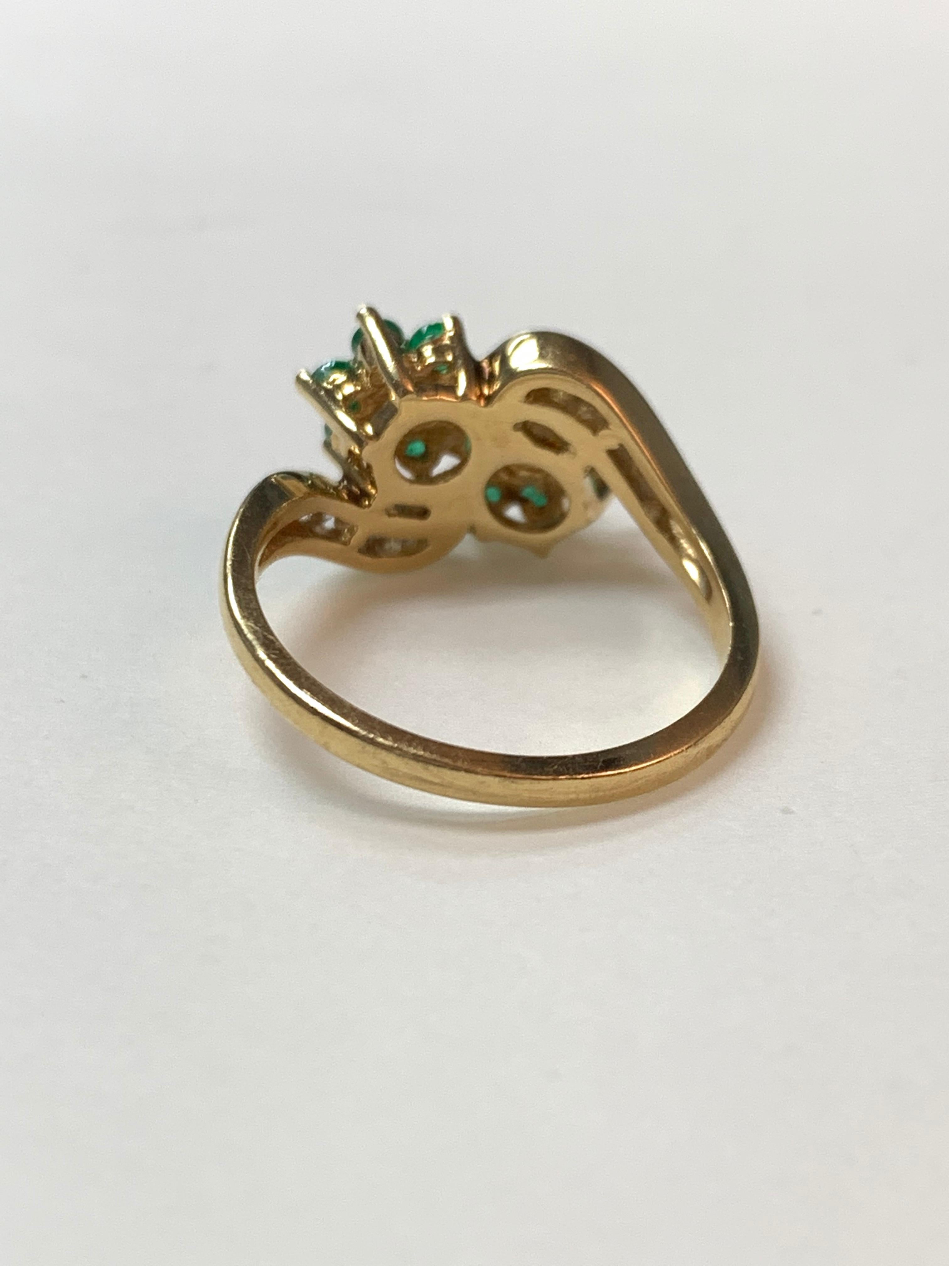 Round Cut Diamond and Emerald Ring in 14 Karat Yellow Gold.