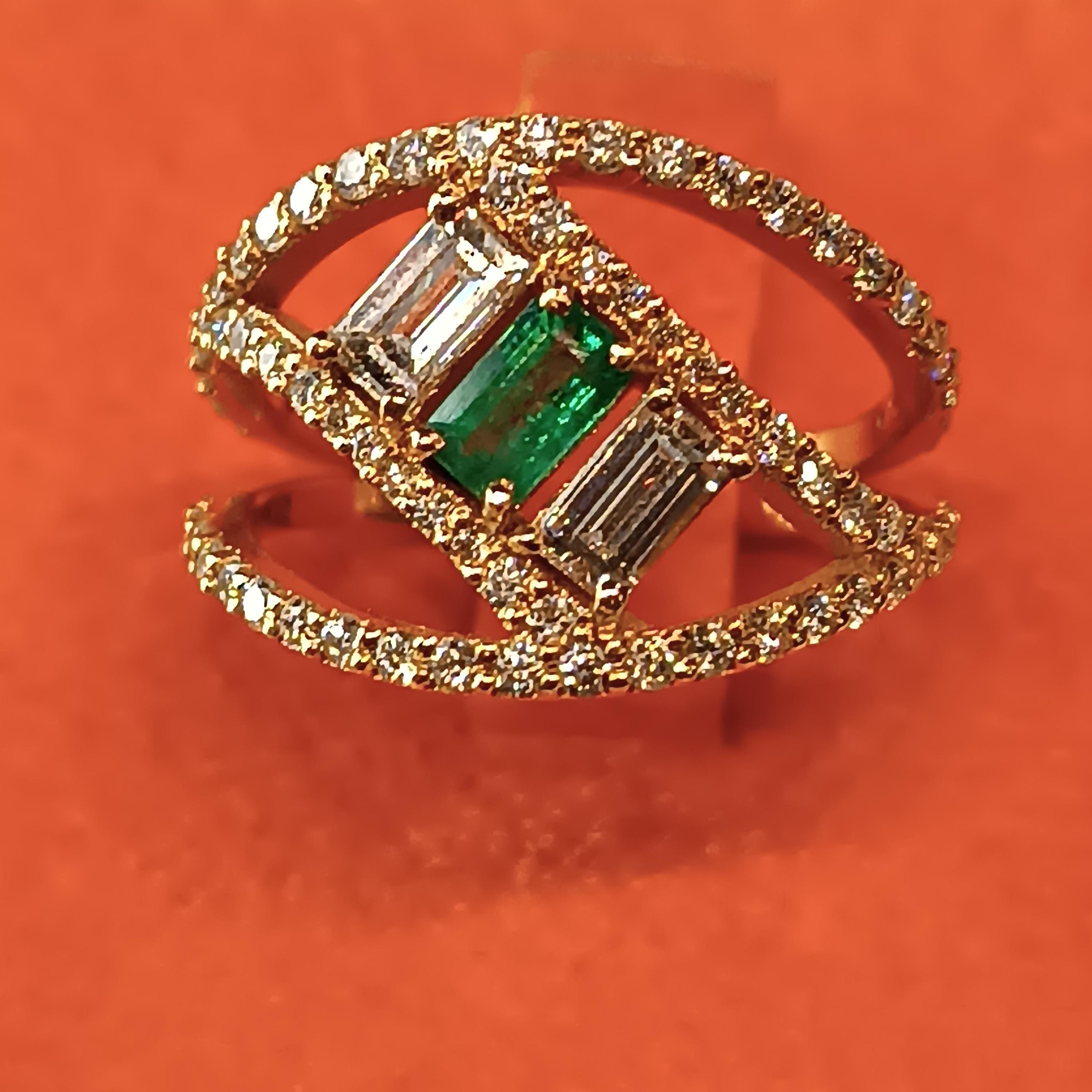 modern design 18 carat Rose gold ring with 0.54 Carats  VS G color 2 baguette cut diamond and 1 baguette cut emeralds of .03 carat each adorned with 64 diamonds for a total of .64 carats. total gross weight gr. 5.07 .Ring size 54
This ring designed
