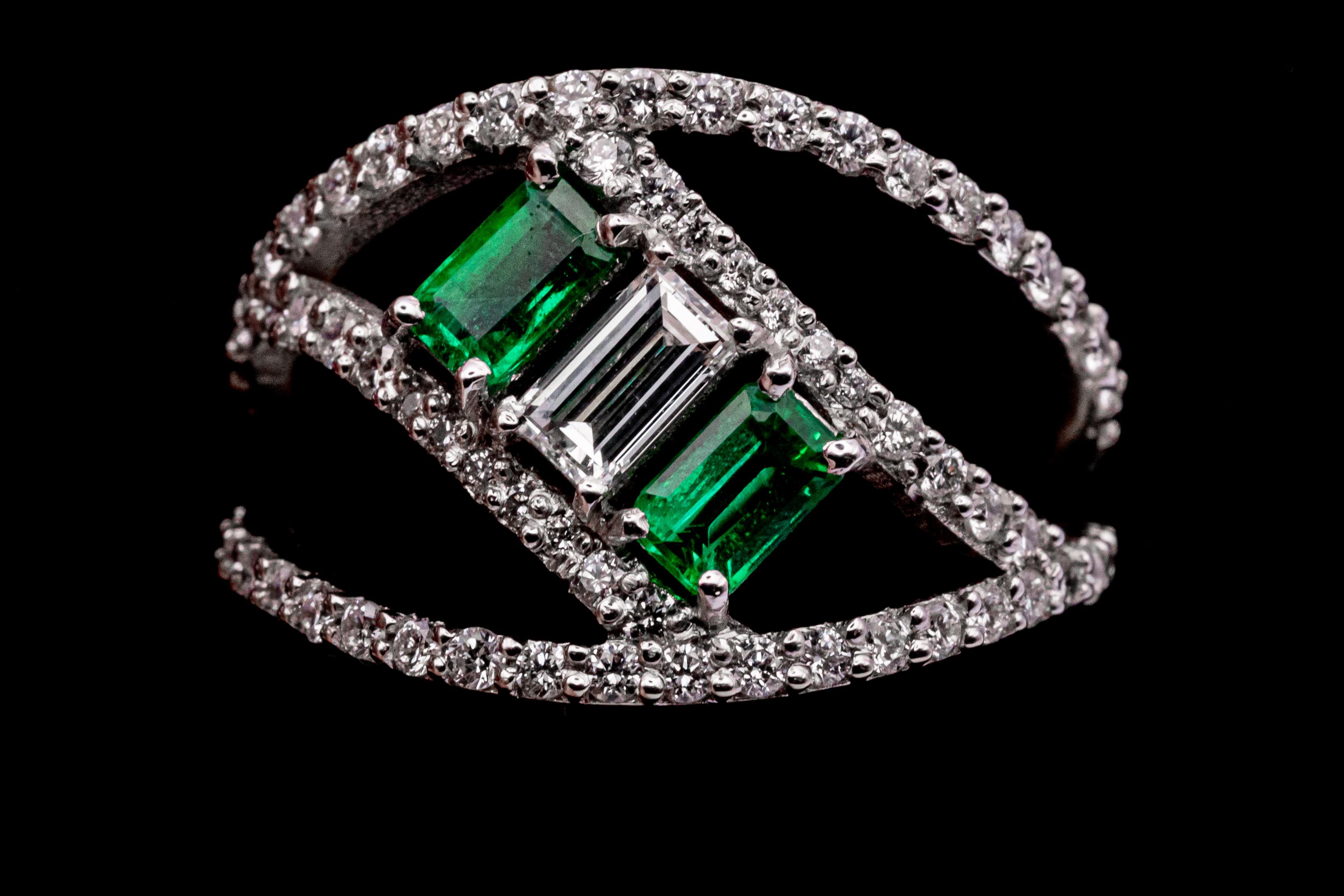 modern design 18 carat white gold ring with .27 VS G color baguette cut diamond and 2 baguette cut emeralds of .30 carat each adorned with 64 diamonds for a total of .64 carats. Gold weights 4 g.
This ring designed by Leo Milano is one of our