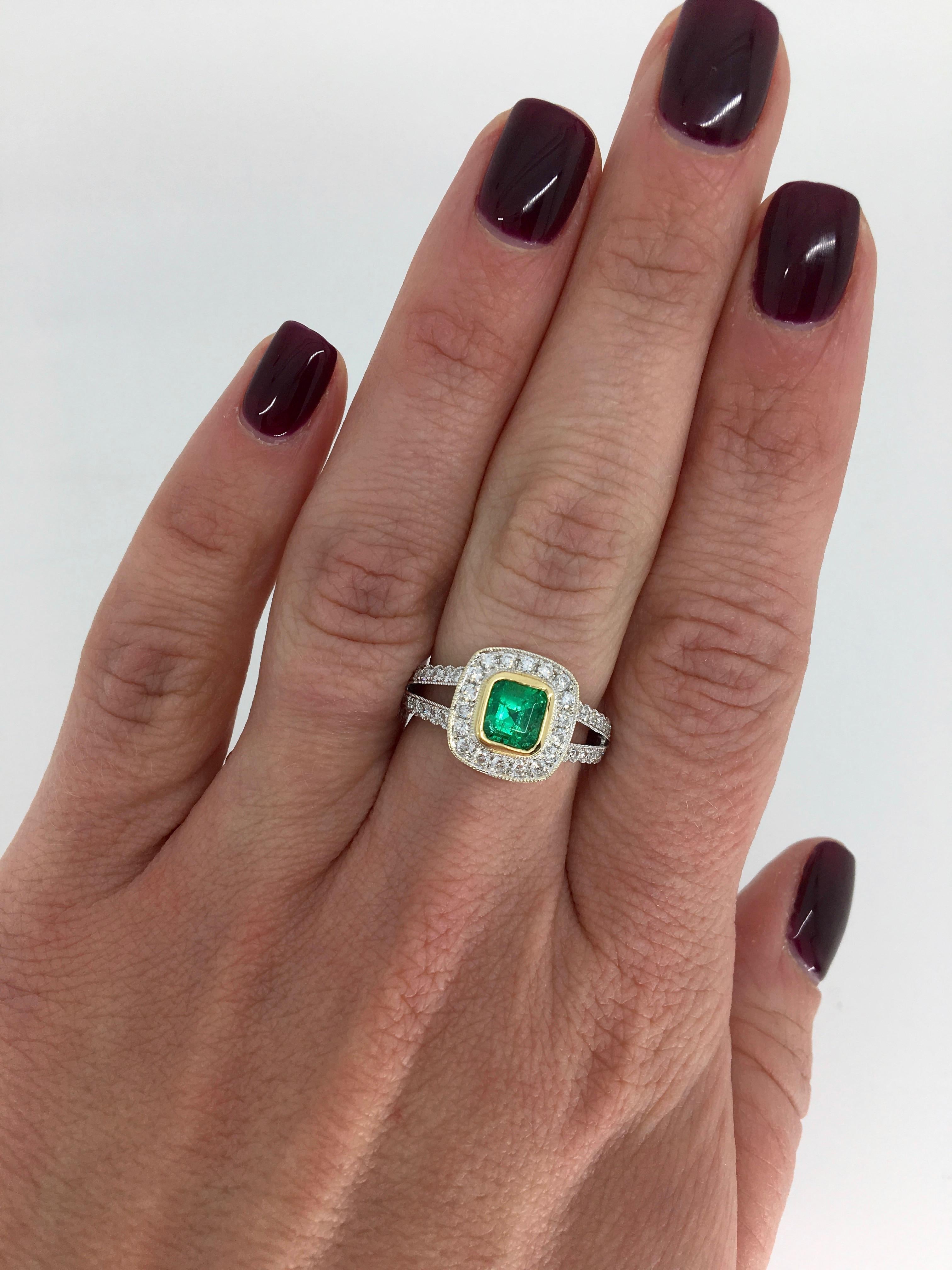 Stunning 18k Two Tone Gold Split shank halo style ring featuring a beautiful approximately 1.00CT Cushion Shaped Emerald. 

Gemstone: Emerald and Diamond
Gemstone Carat Weight: Approximately 1.00CT Cushion Shaped Emerald
Diamond Carat Weight: