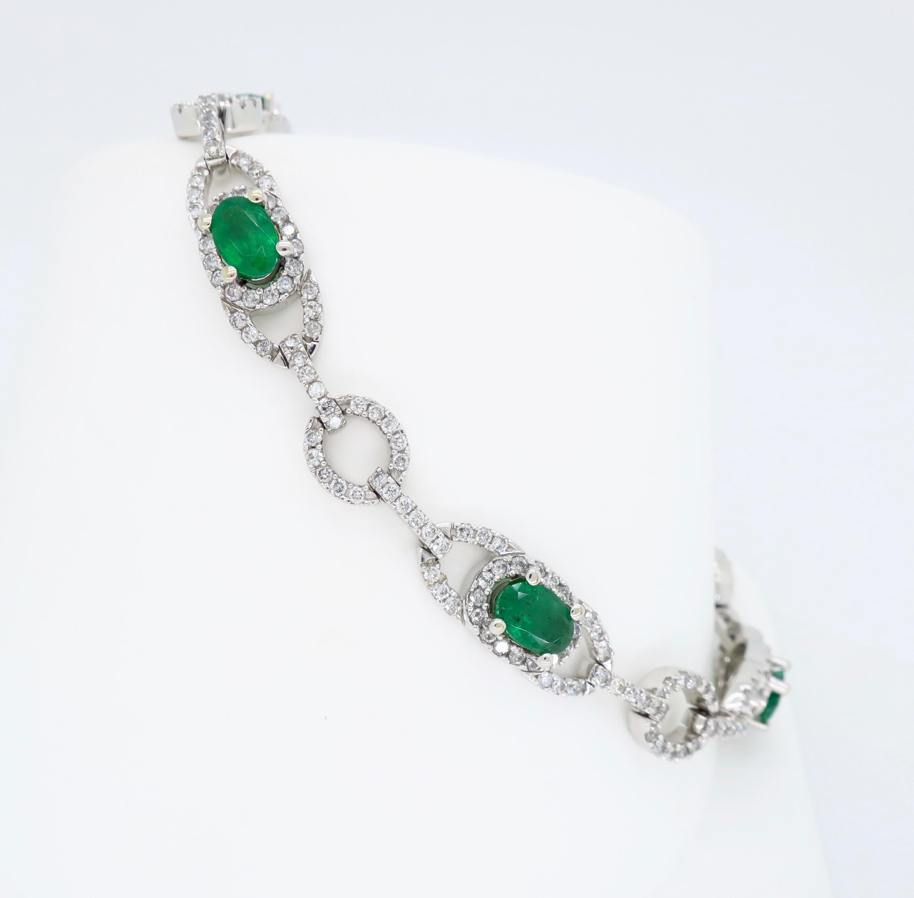 This stunning bracelet features 2.50CTW of oval cut emeralds  surrounded by approximately 2.05CTW of Round Brilliant Cut Diamonds.

Gemstone: Emerald & Diamond
Gemstone Carat Weight: 6 Oval Cut Emeralds, 2.50CTW 
Diamond Cut: Round Brilliant Cut