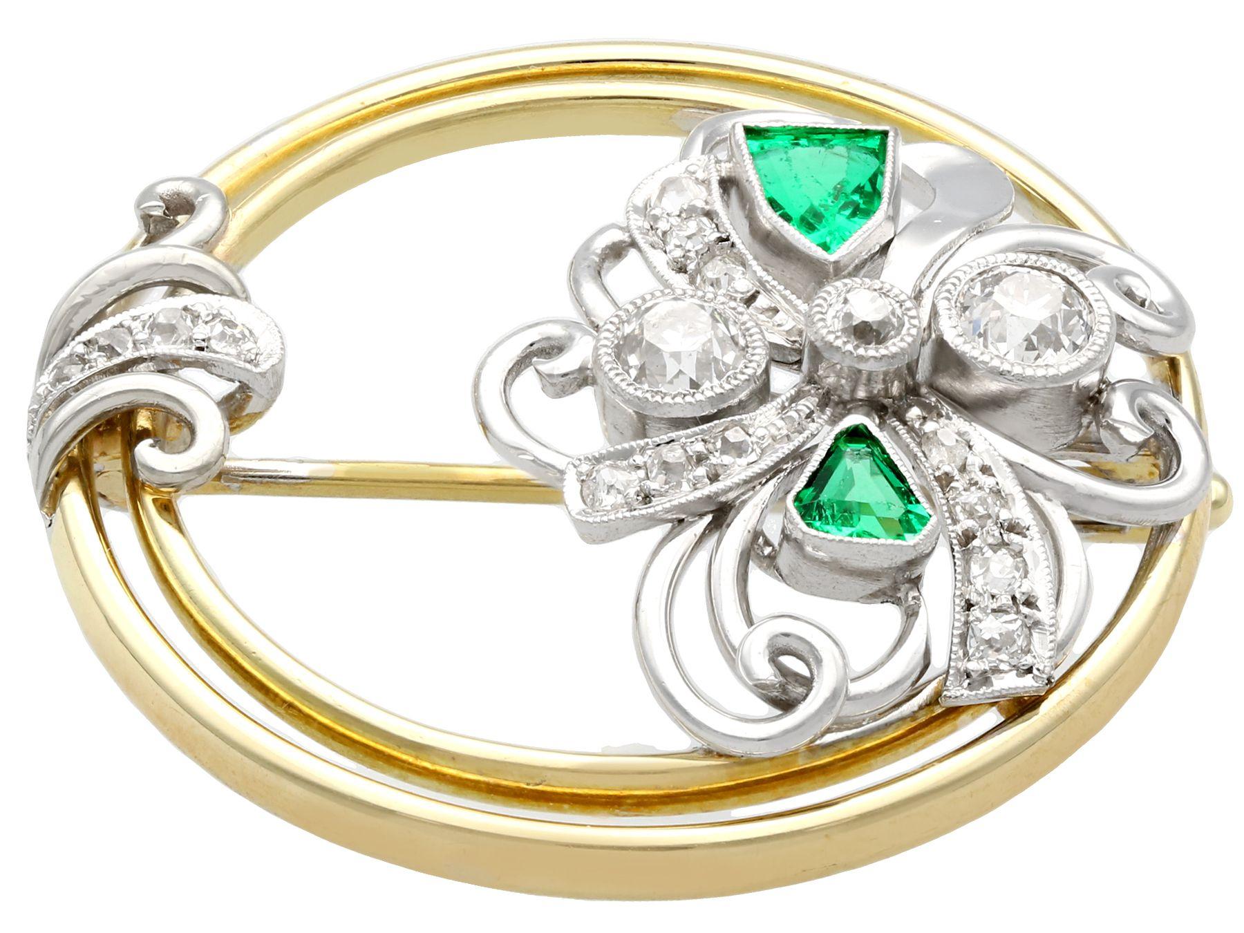A stunning, fine and impressive antique 0.66 carat diamond and 0.59 carat emerald, 14 karat yellow gold and 14k white gold wreath brooch in the Art Deco style; part of our diverse antique jewelry and estate jewelry collections

This stunning antique