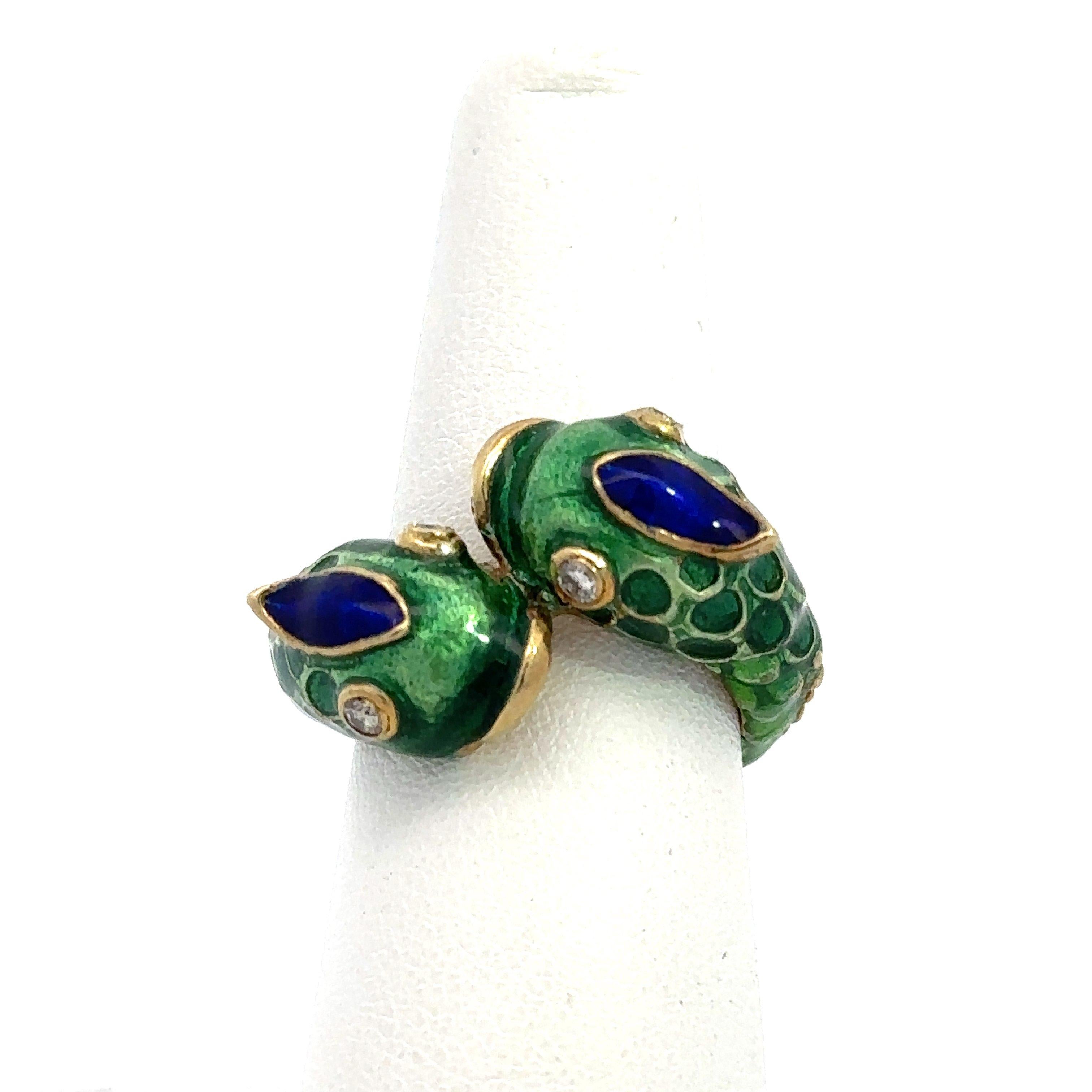 This Vintage Bypass Ring is Crafted in 14kt Yellow Gold and Dates from The 1960s.
It Features Beautiful Green and Blue Enamel Detailing for The Scales with Textured Gold along The Shank. 
The Enamel is in Excellent Condition. 
It Has Four Brilliant