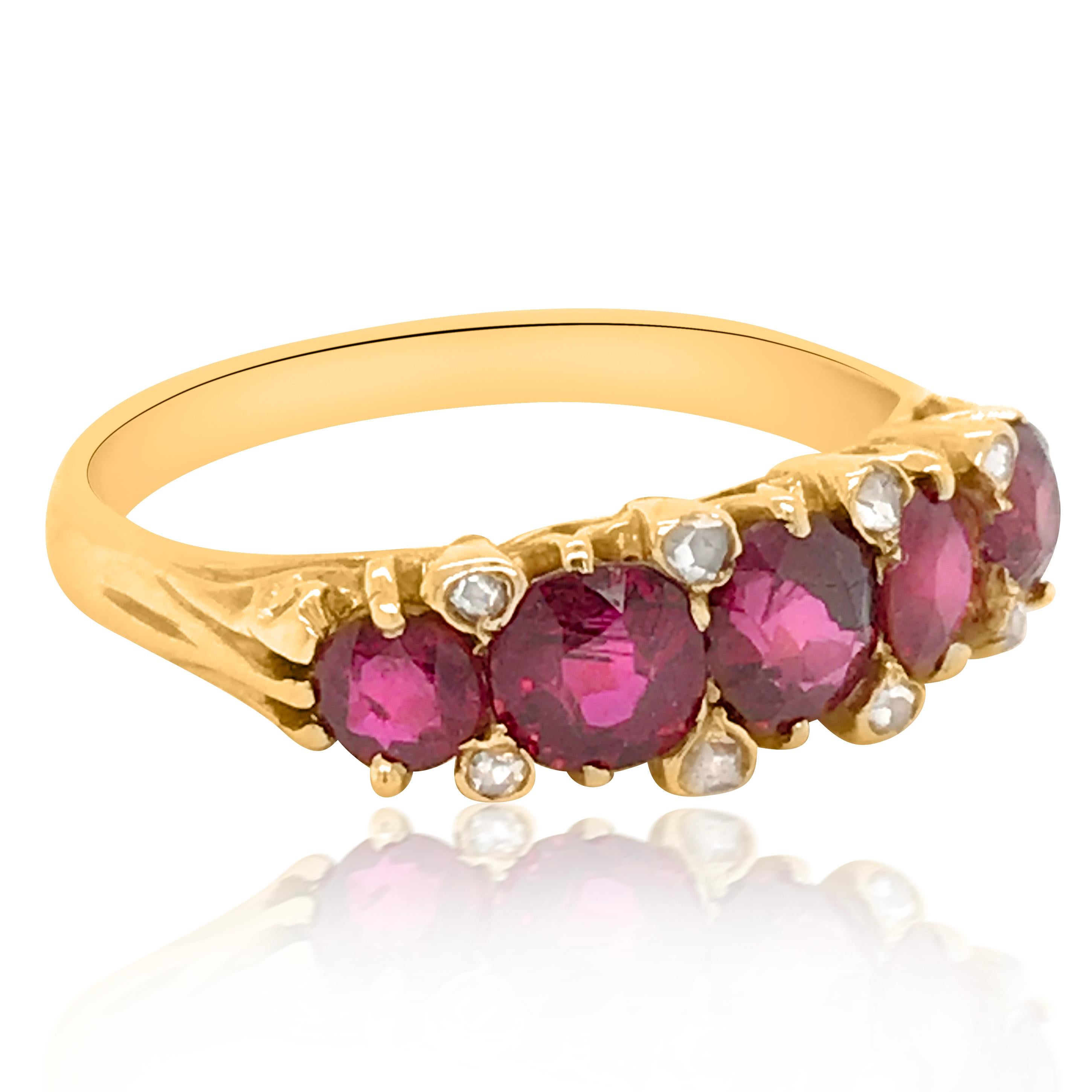 This antique shimmering ruby and diamond ring is crafted in 18K yellow gold, weighing 4.68 grams and in ring size 9.5 (adjustable). It is adorned with 5 rubies in a row, weighing cumulatively approx. 2.09 carats. Enhanced with 8 rose-cut diamonds