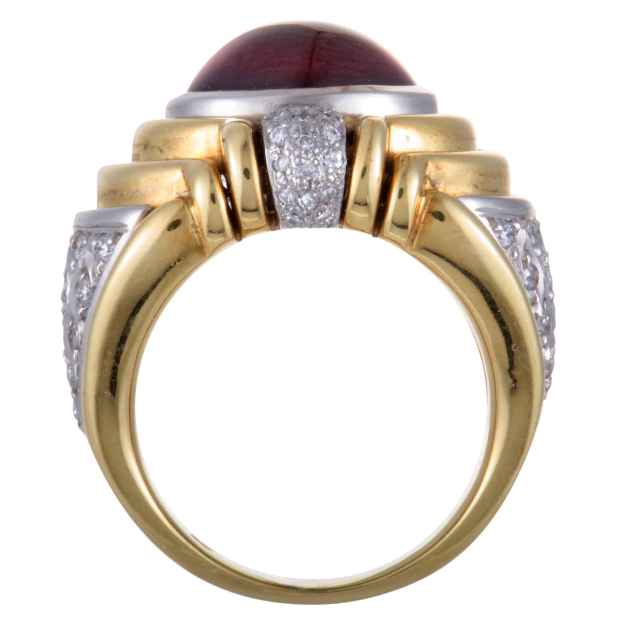 The ever-luxurious combination of classy 18K yellow gold and prestigious platinum is beautifully accentuated by an attractive garnet and a plethora of dazzling diamonds in this fabulous ring. The garnet weighs 6.52 carats and the diamonds amount to