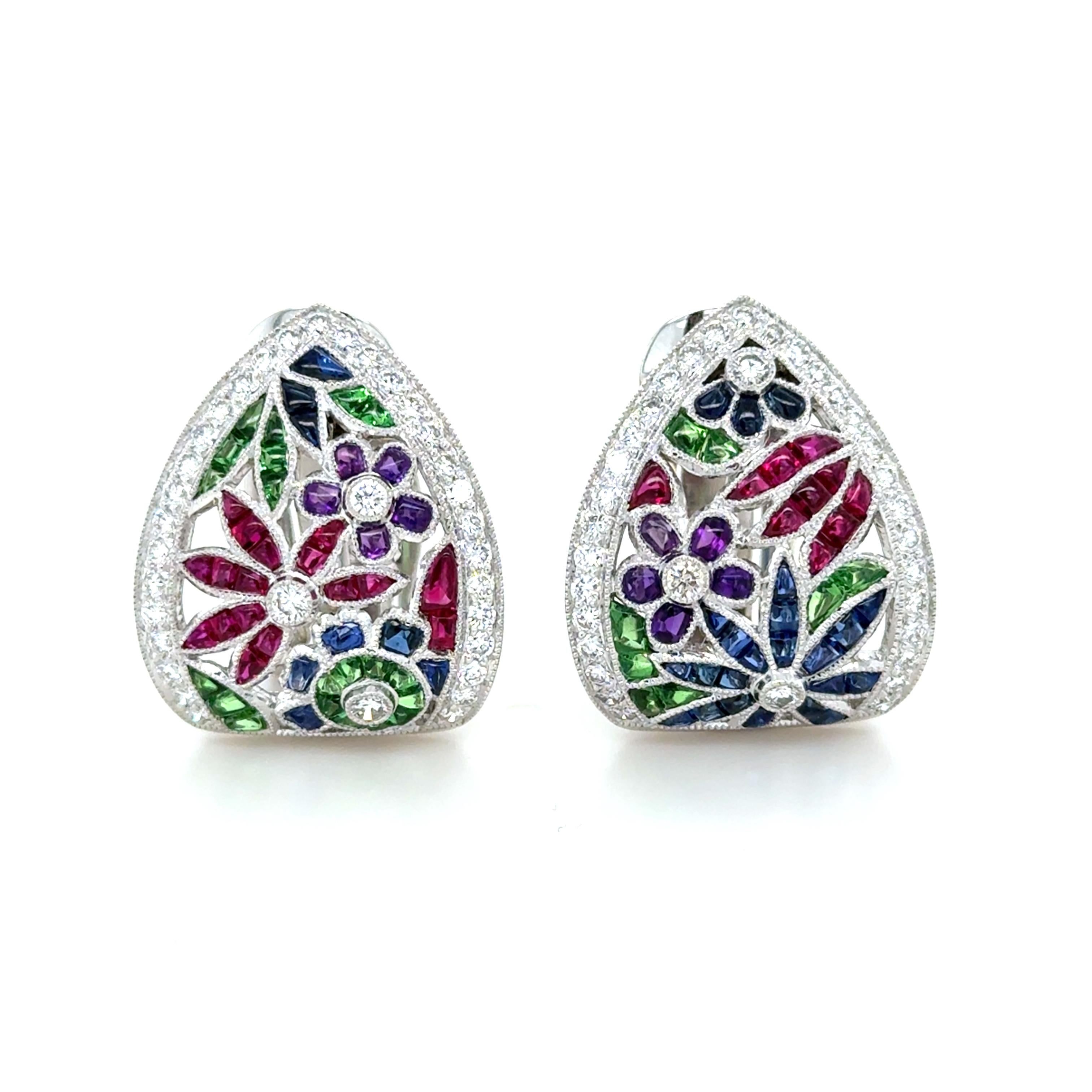 These colorful earrings have a beautiful floral design decorated in buff top calibre cut rubies, sapphires, tsavorite garnets and amethyst and 68 round brilliant cut diamonds weighing 1.50 carats total. The perfect touch of color!

Measurements: 7/8