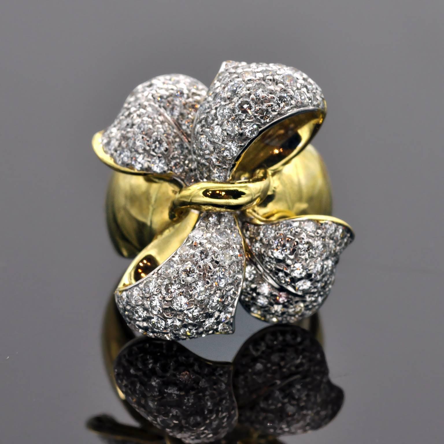 Stunning earring and ring set in the shape of an elegant bow . The Clip-on Earring are pave set with 5.26 carat of diamonds, the Ring set with 1.85 carat of diamonds both G VS. 
