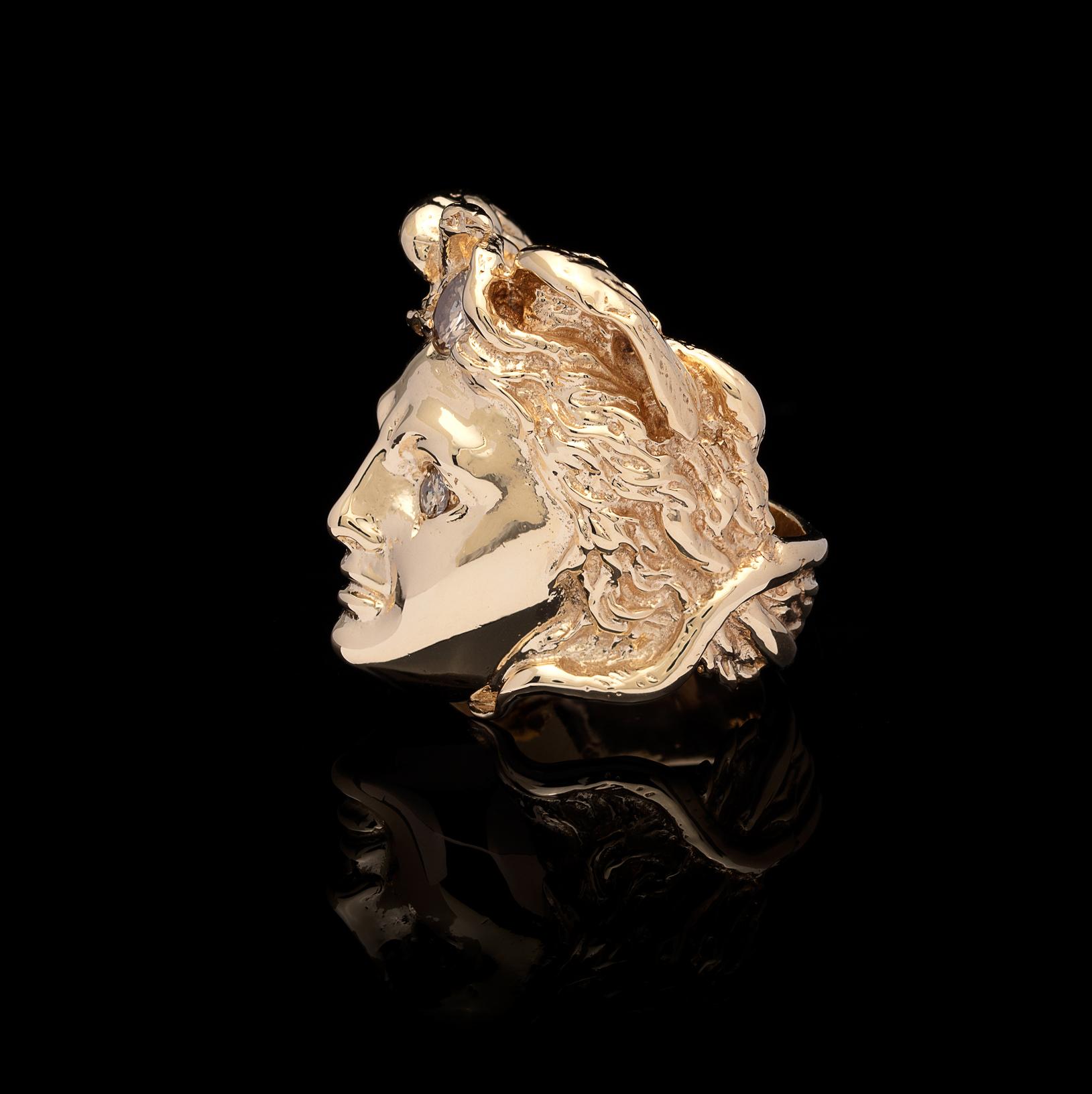 Mythical figure comes to life! This 14k gold Medusa ring is set with round brilliant-cut diamond eyes and one more in her hair of snakes. The ring weighs 33.50 grams, and is currently a size 7 3/4, with easy adjustment up or down. Greek mythology in