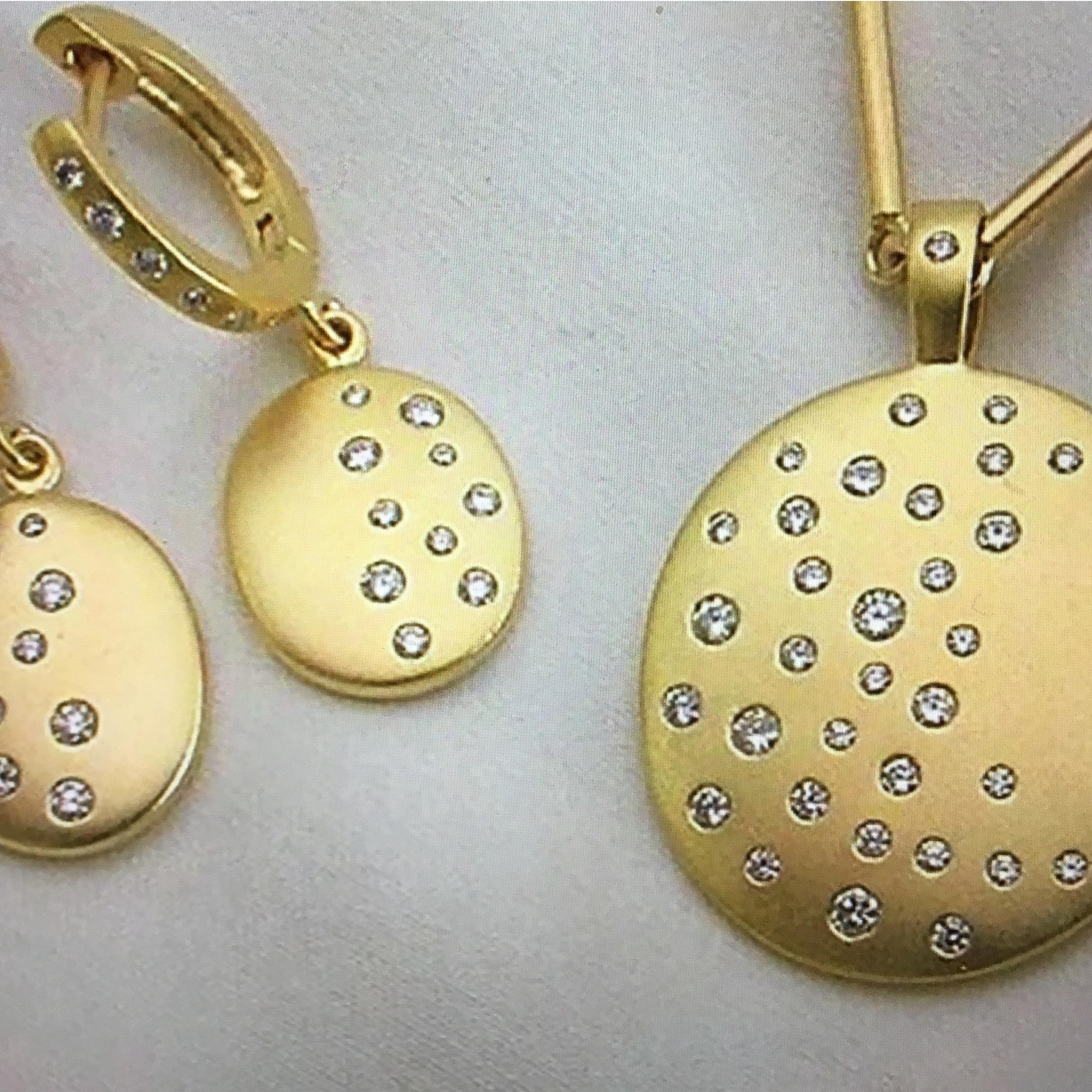 Beautiful discs of gold with Nancy's signature satin finish are randomly, smooth set with over a half carat of diamonds to give the impression of the night sky.  0.59 carats of brilliant cut diamonds help create these stylish, wearable, everyday