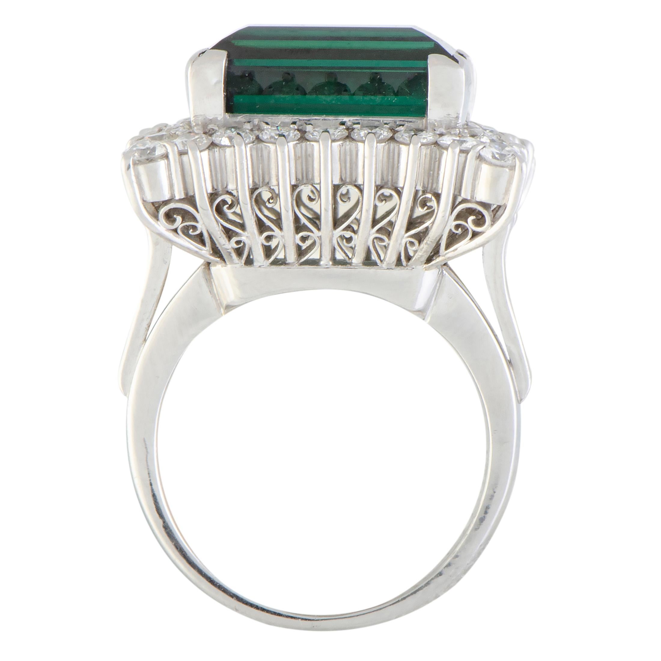 Add a sophisticated touch of regal prestige to your ensembles with this wonderful ring that boasts an exceptionally elegant design and stunningly luxurious décor. The ring is made of platinum and set with an eye-catching green tourmaline that weighs